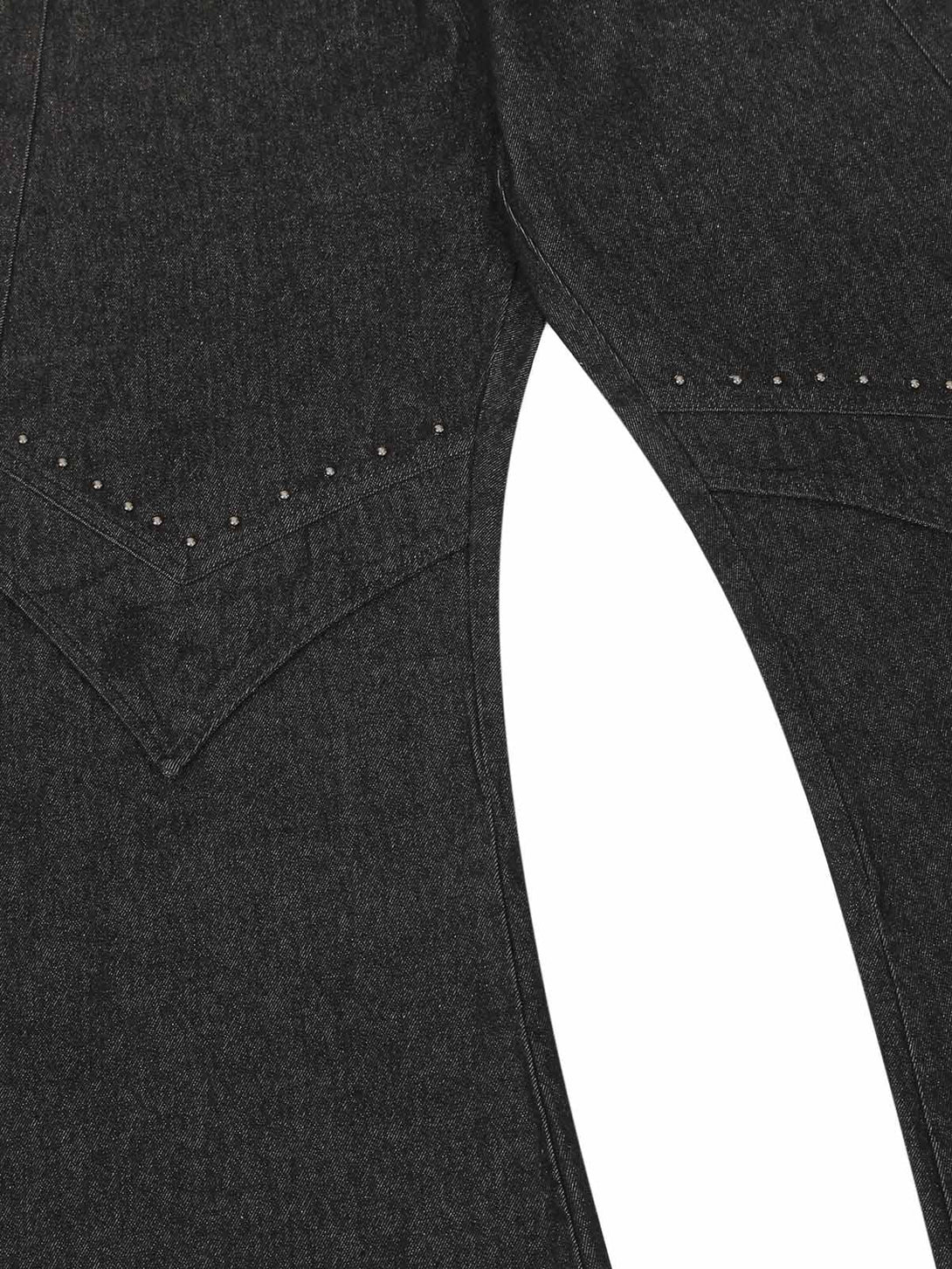 Detailed fabric and stitching of TALISHKO's deconstructed rivet scimitar jeans.