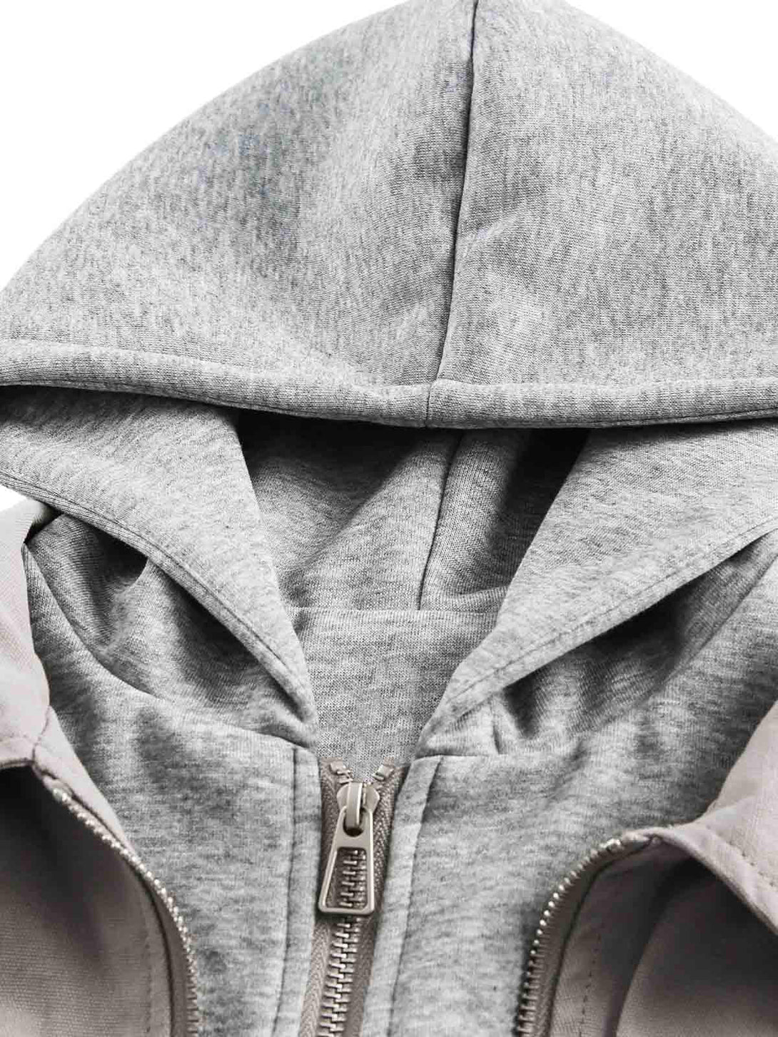 Detailed view of a gray hooded jacket by TALISHKO, highlighting its layered, deconstructed design.