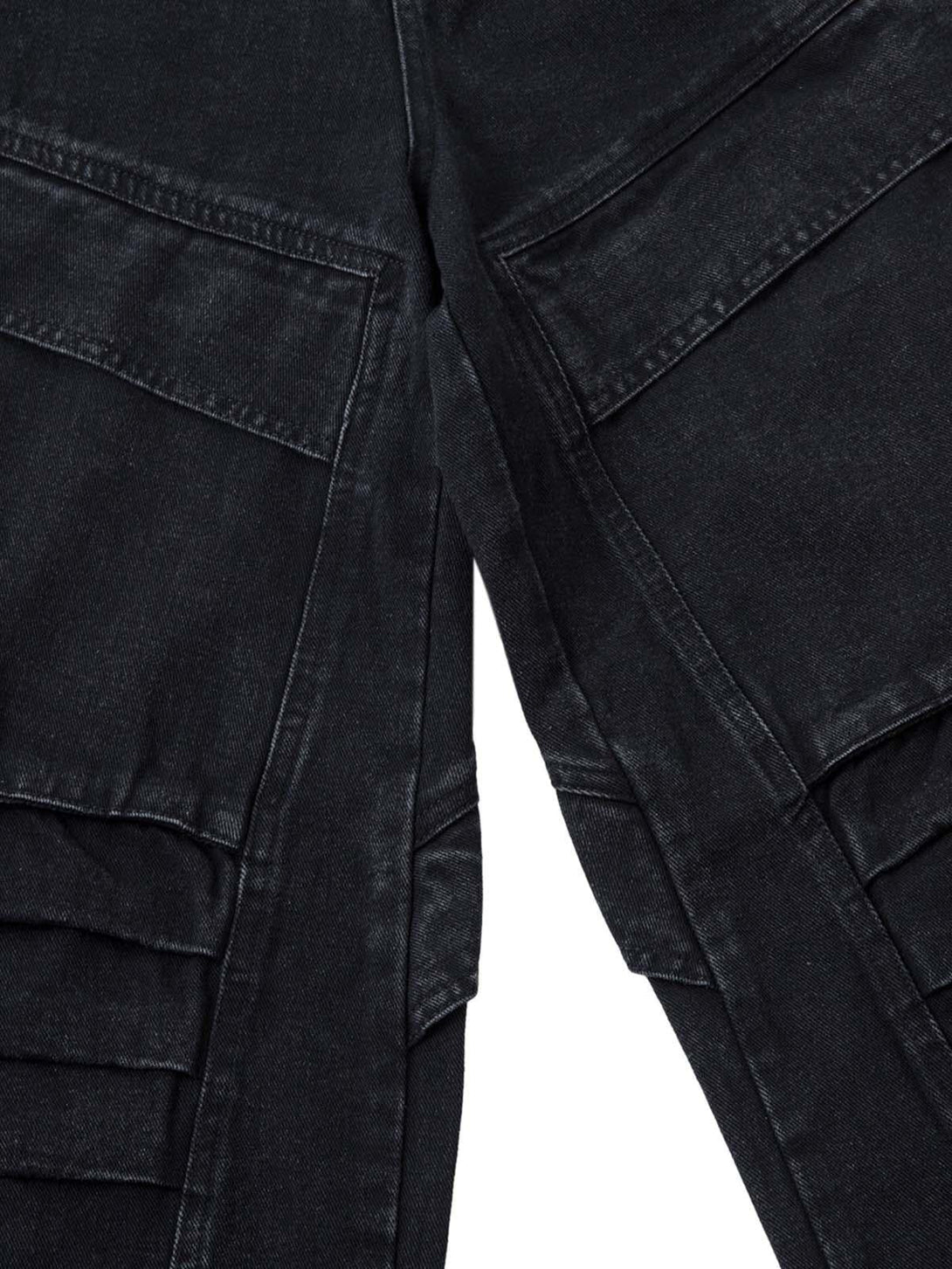 Zoomed-in texture of black cargo jeans showcasing pleated pockets and detail by TALISHKO.