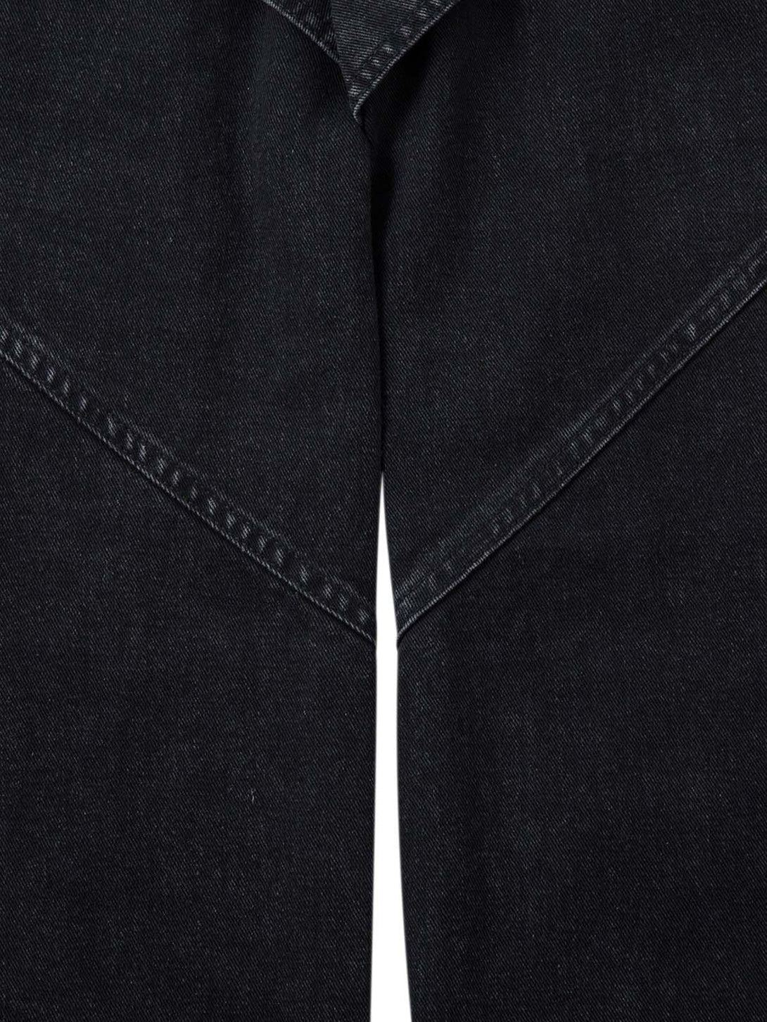 Close-up of black deconstructed cargo jeans' stitching and pleated design by TALISHKO.