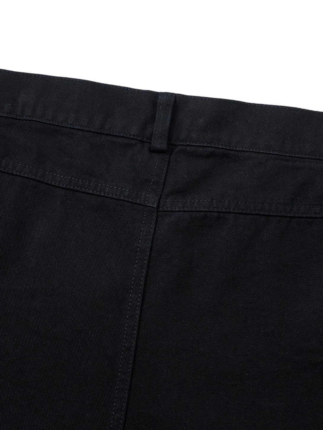 A tight crop highlighting the back stitching and belt loop of TALISHKO's deconstructed cargo jeans.