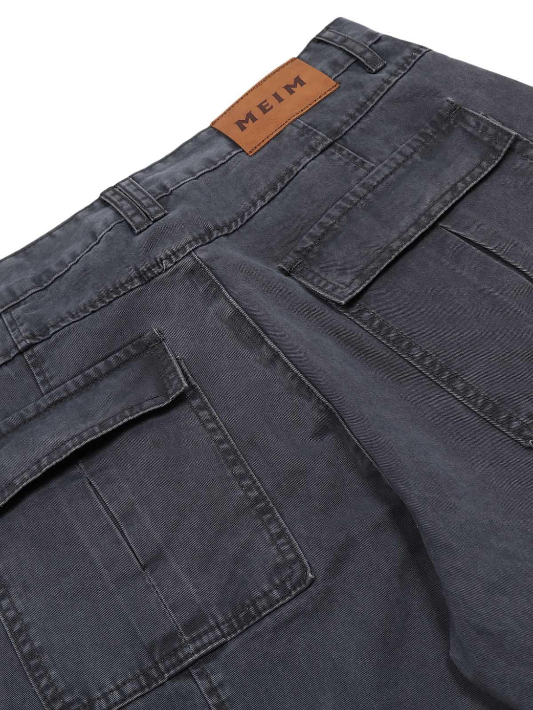 Back pocket detail of TALISHKO deconstructed jeans, highlighting rugged style and craftsmanship.
