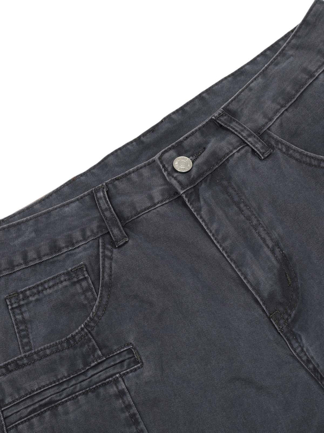 A detailed view of TALISHKO deconstructed jeans, showcasing intricate stitching and pocket design.