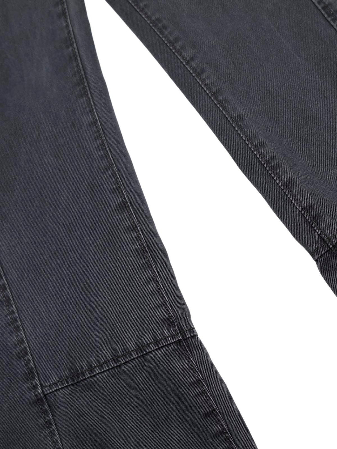 Zoomed-in texture of TALISHKO deconstructed split jeans, highlighting unique stitching details.
