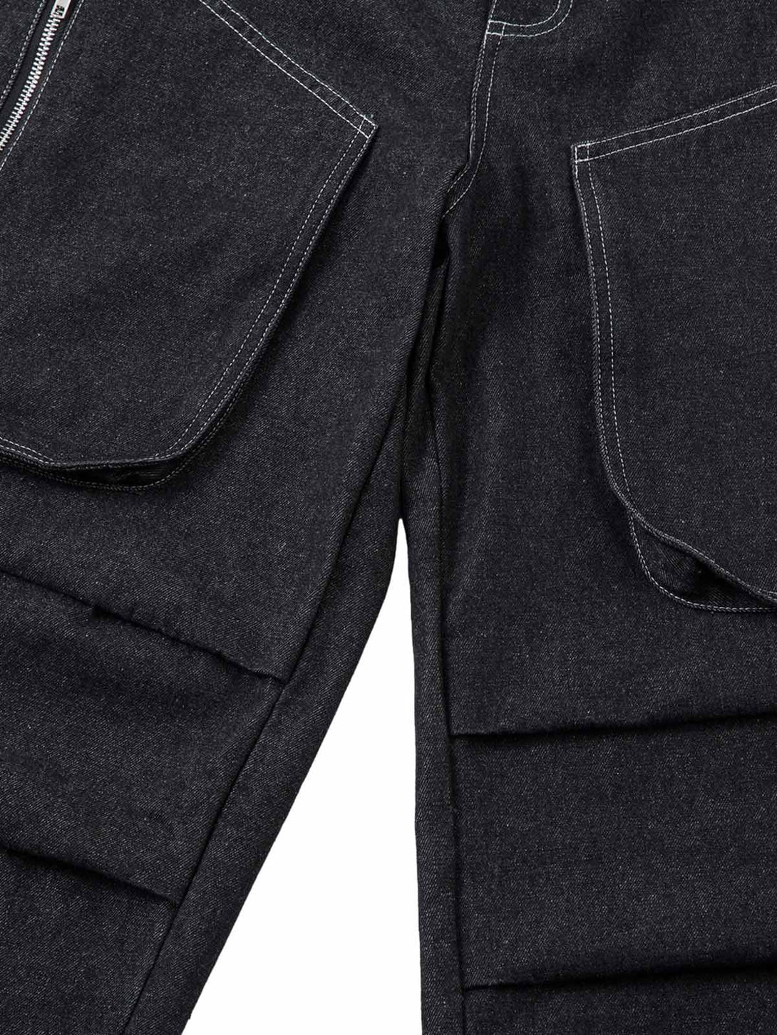 Close-up of TALISHKO's deconstructed jeans, highlighting pleated design and large pockets.
