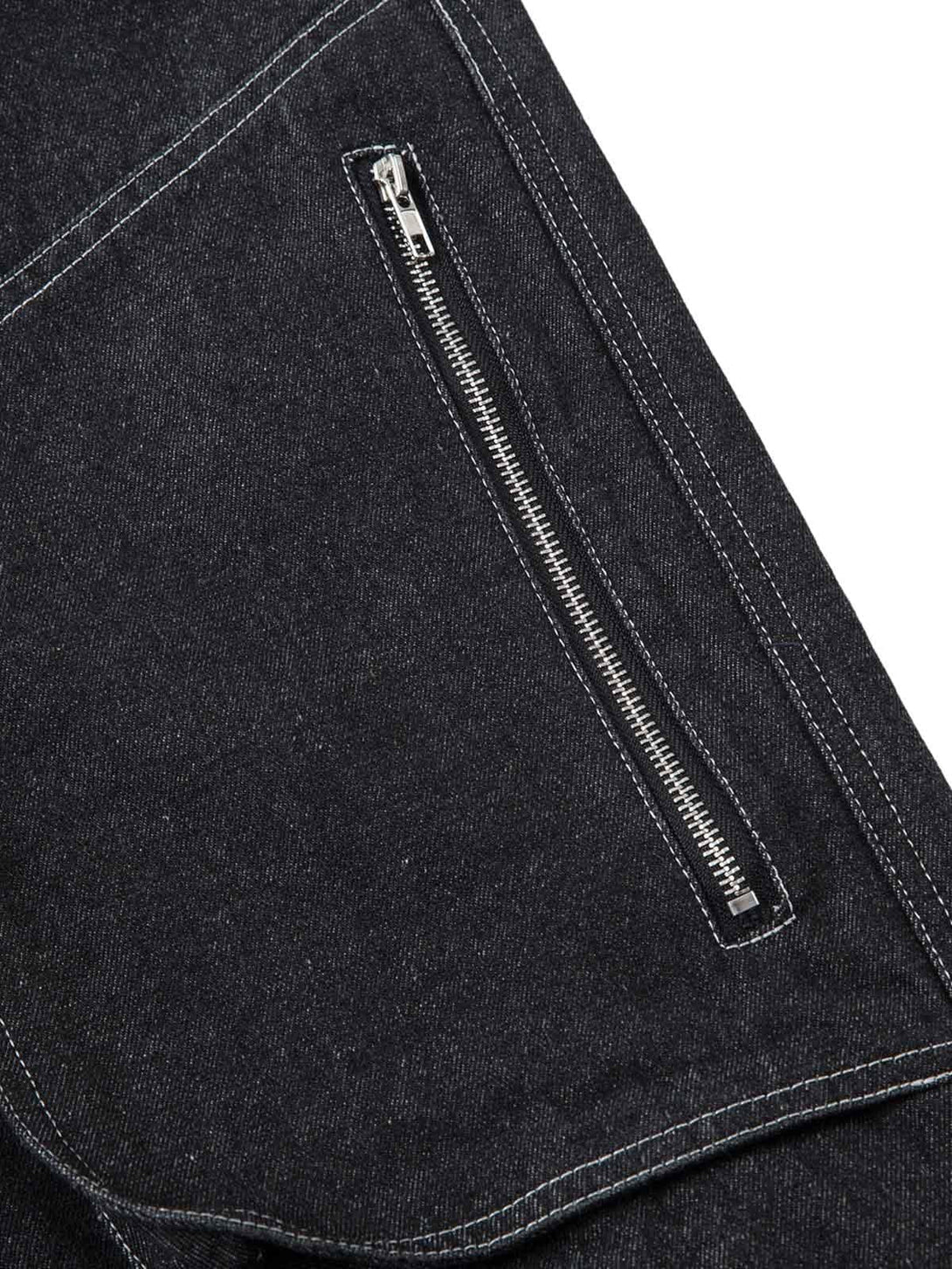 Intricate look at TALISHKO's deconstructed jeans, focusing on zipper detail and topstitching.