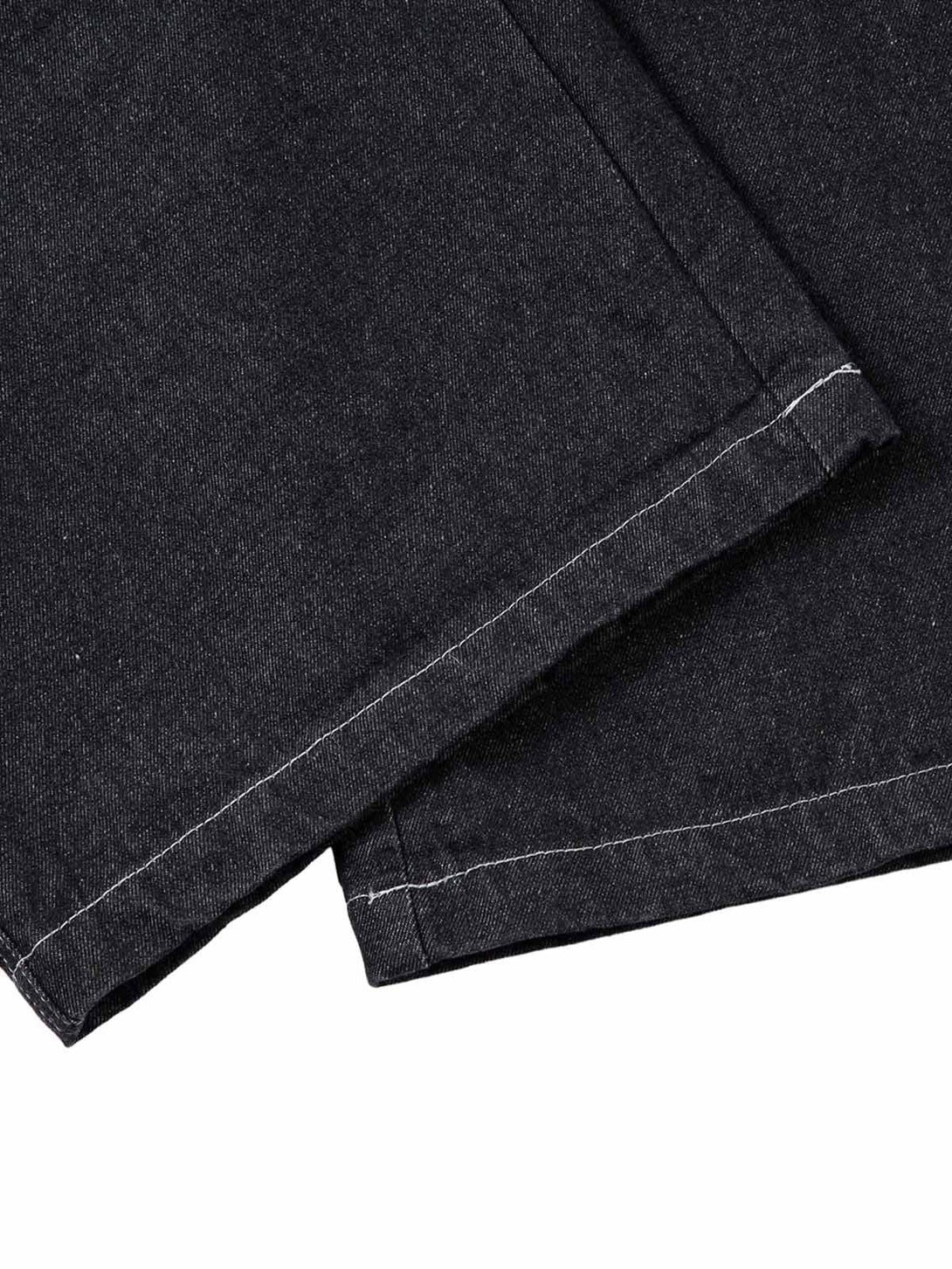 Detailed view of TALISHKO's jeans hem, showcasing the topstitching and fabric texture.