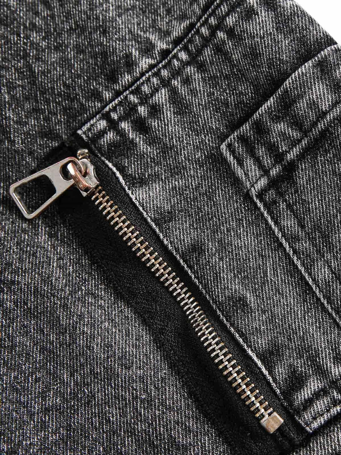 Focusing on the zipper detail of TALISHKO's deconstructed denim jacket, highlighting its texture.