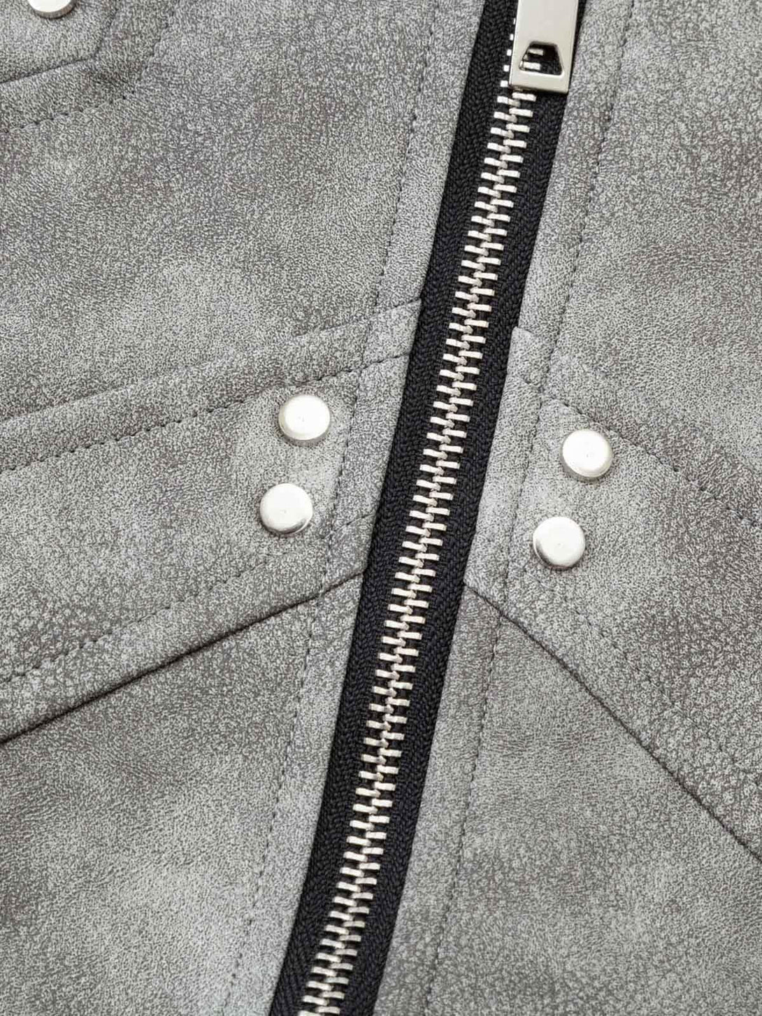 "Zoomed-in view of TALISHKO's bomber jacket zipper and textured leather details."