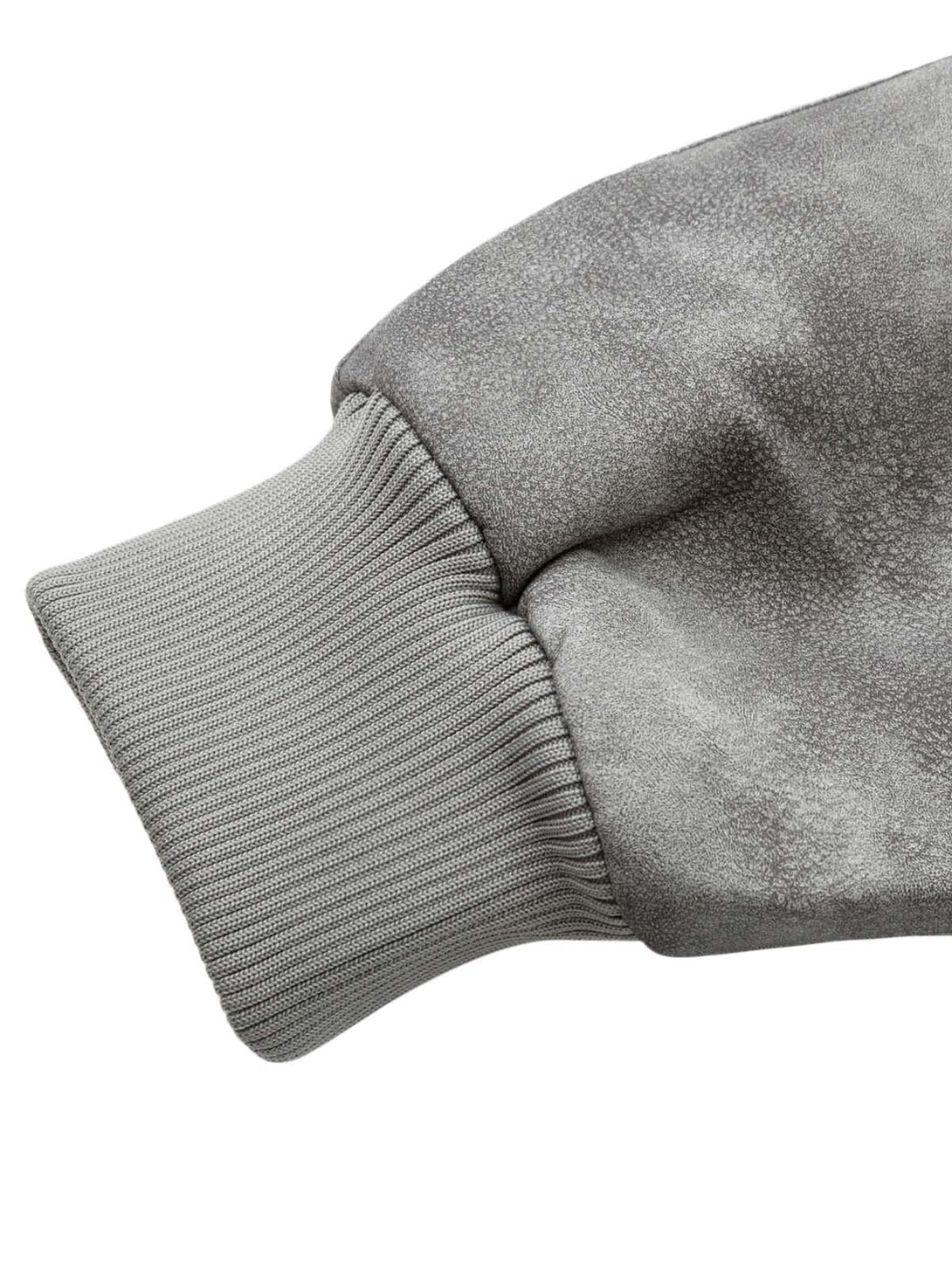 "Detailed sleeve texture of TALISHKO's deconstructed leather bomber jacket, highlighting craftsmanship."