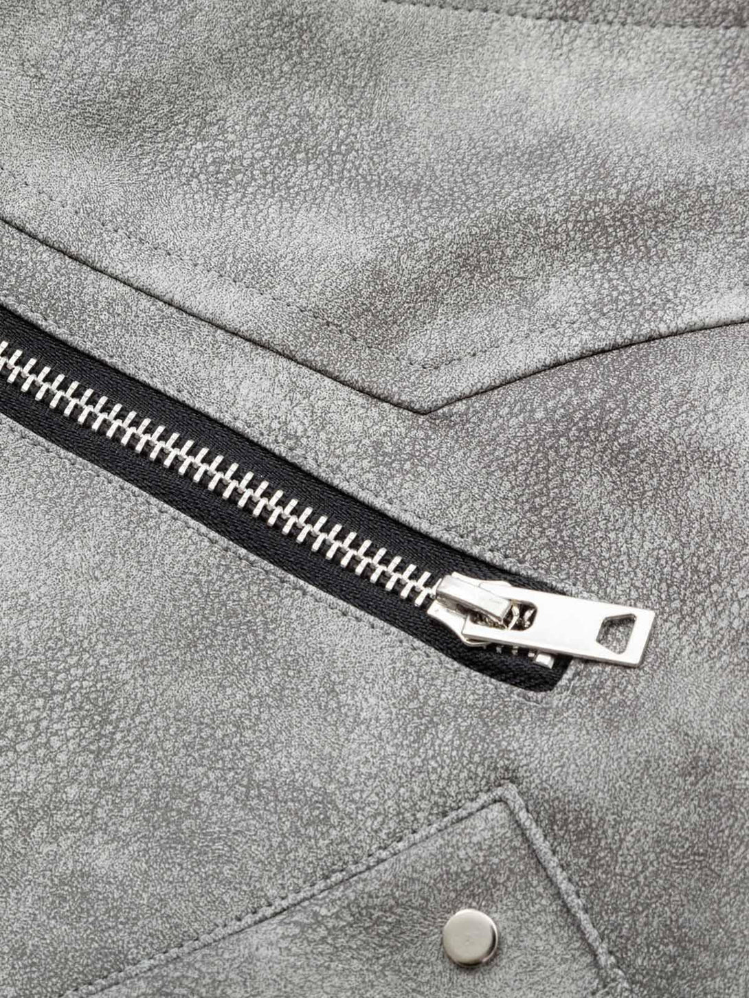 "Textured leather and zipper detail on TALISHKO's bomber jacket, showcasing deconstructed style."