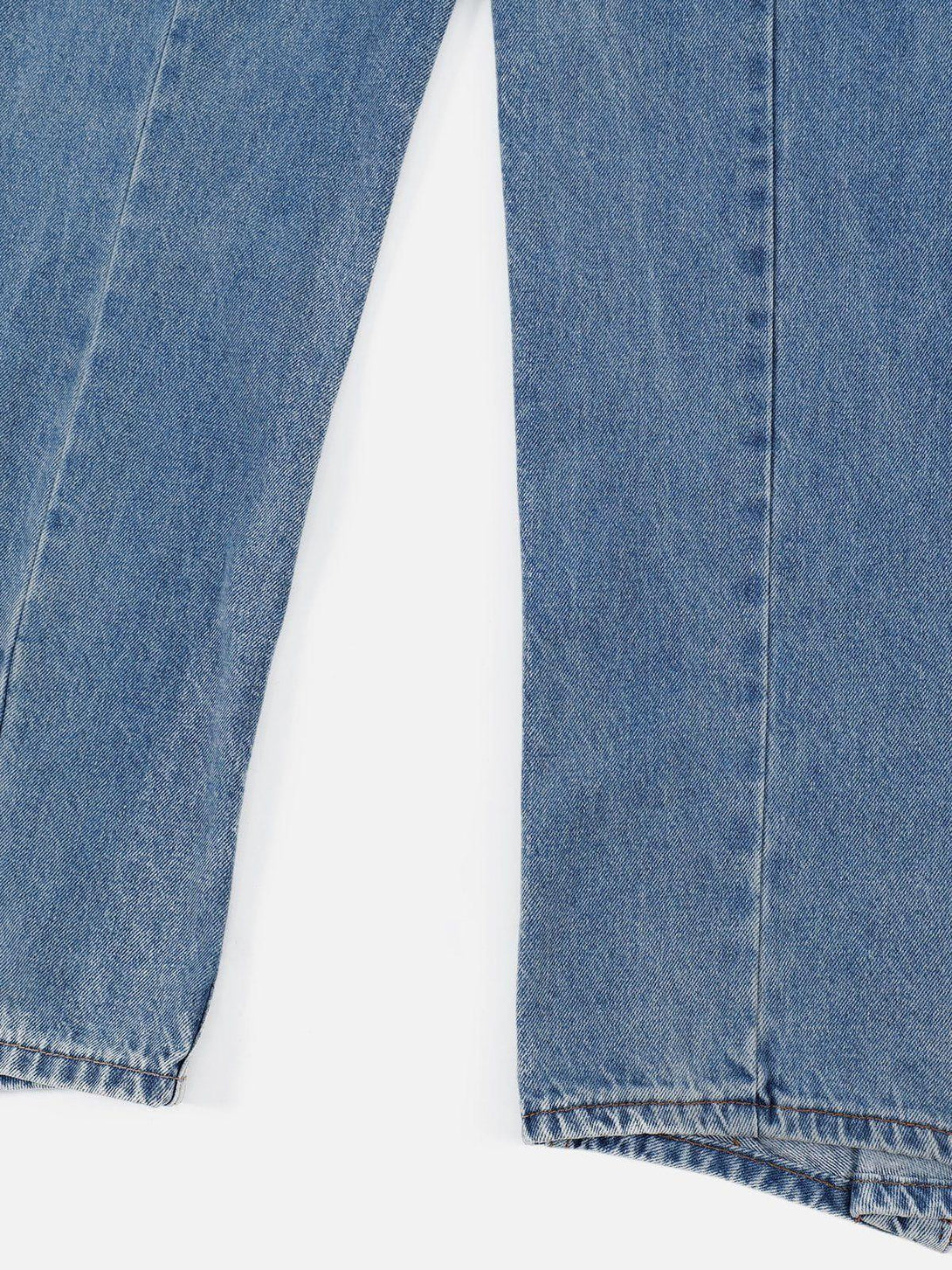 A close-up of TALISHKO's deconstructed loose jeans, highlighting the unique denim texture.