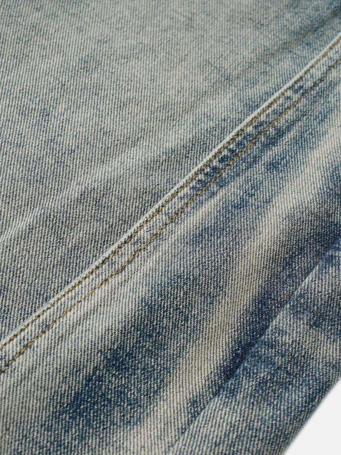Intricate look at TALISHKO's deconstruction patchwork jeans fabric and stitching detail.