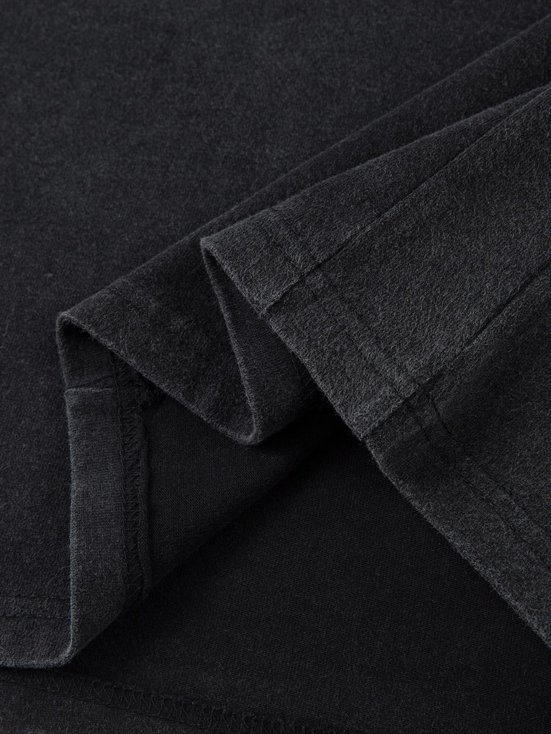 Detailed fabric and stitching of TALISHKO's deconstructed split T-shirt, showcasing texture.