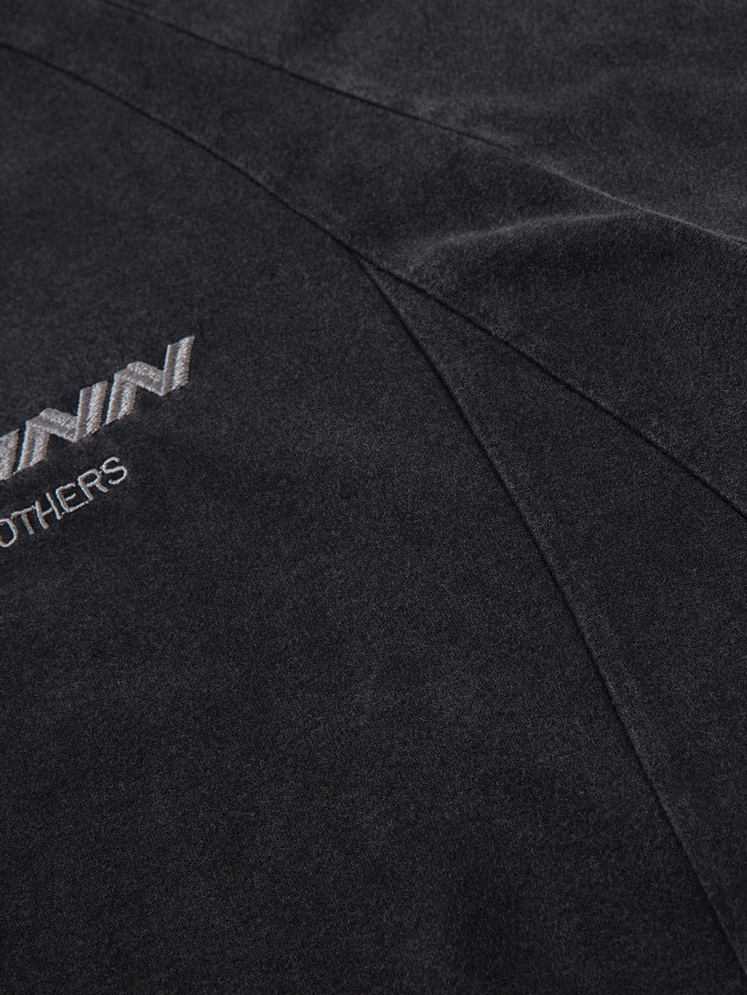 Close-up of TALISHKO's deconstructed T-shirt, highlighting the intricate embroidered design.