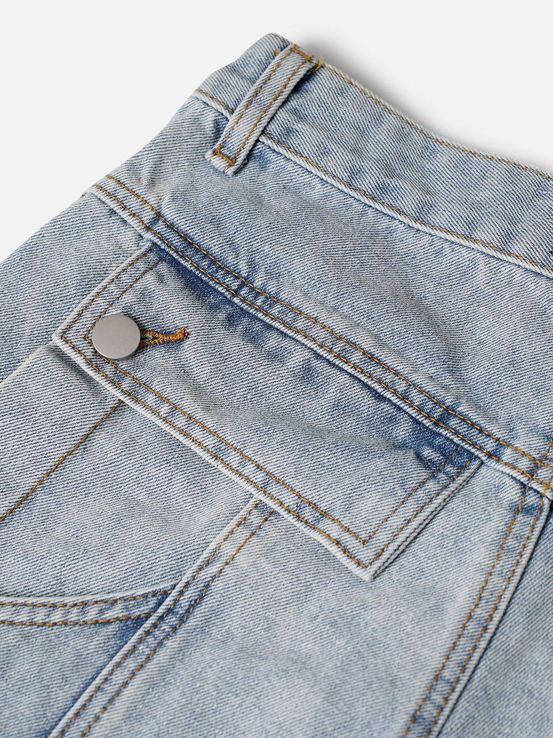 Intricate look at TALISHKO deconstructive patchwork jorts, highlighting unique pocket details.