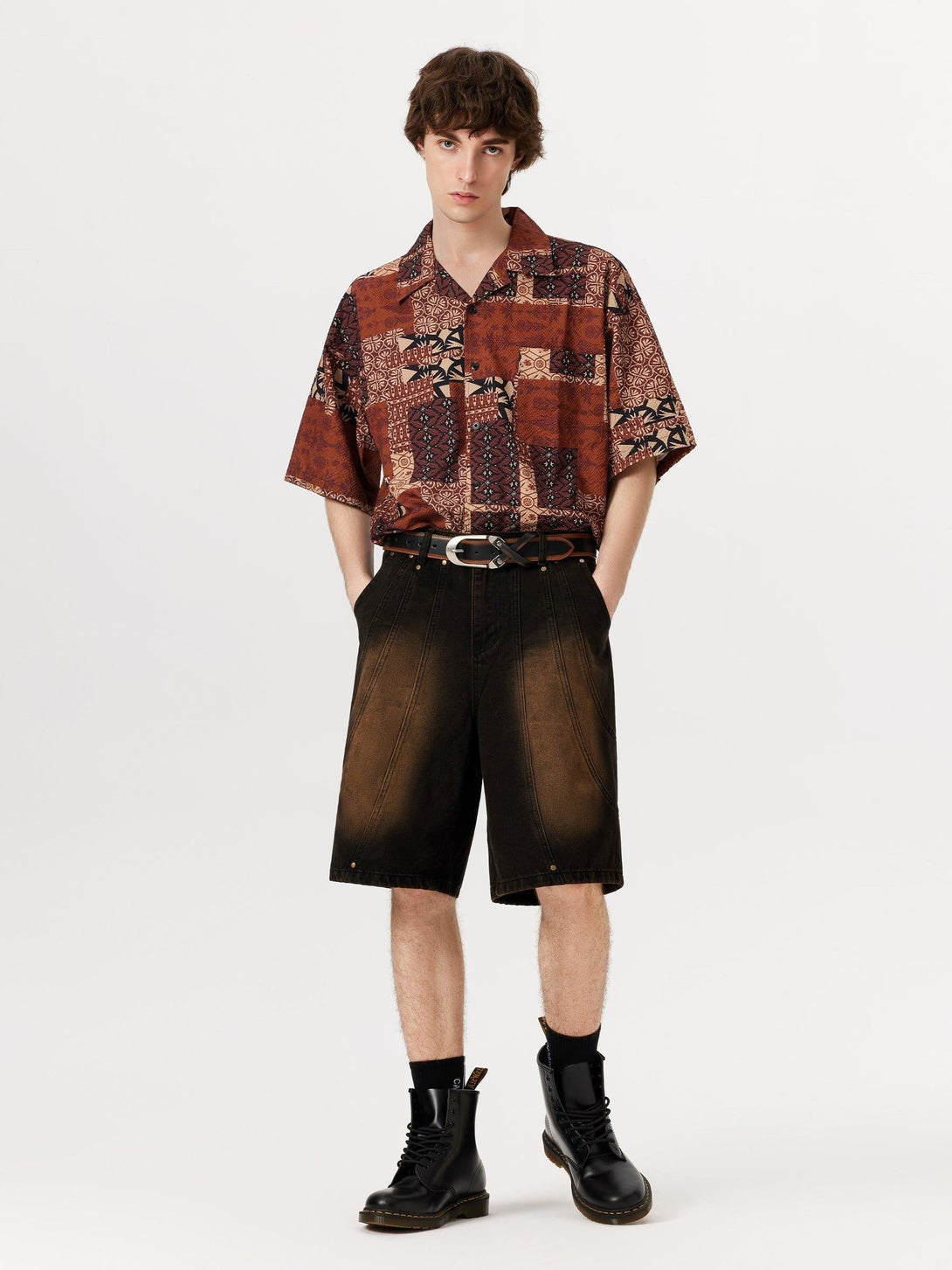 Model in a patterned shirt and deconstructive washed jorts by TALISHKO, styled with boots.