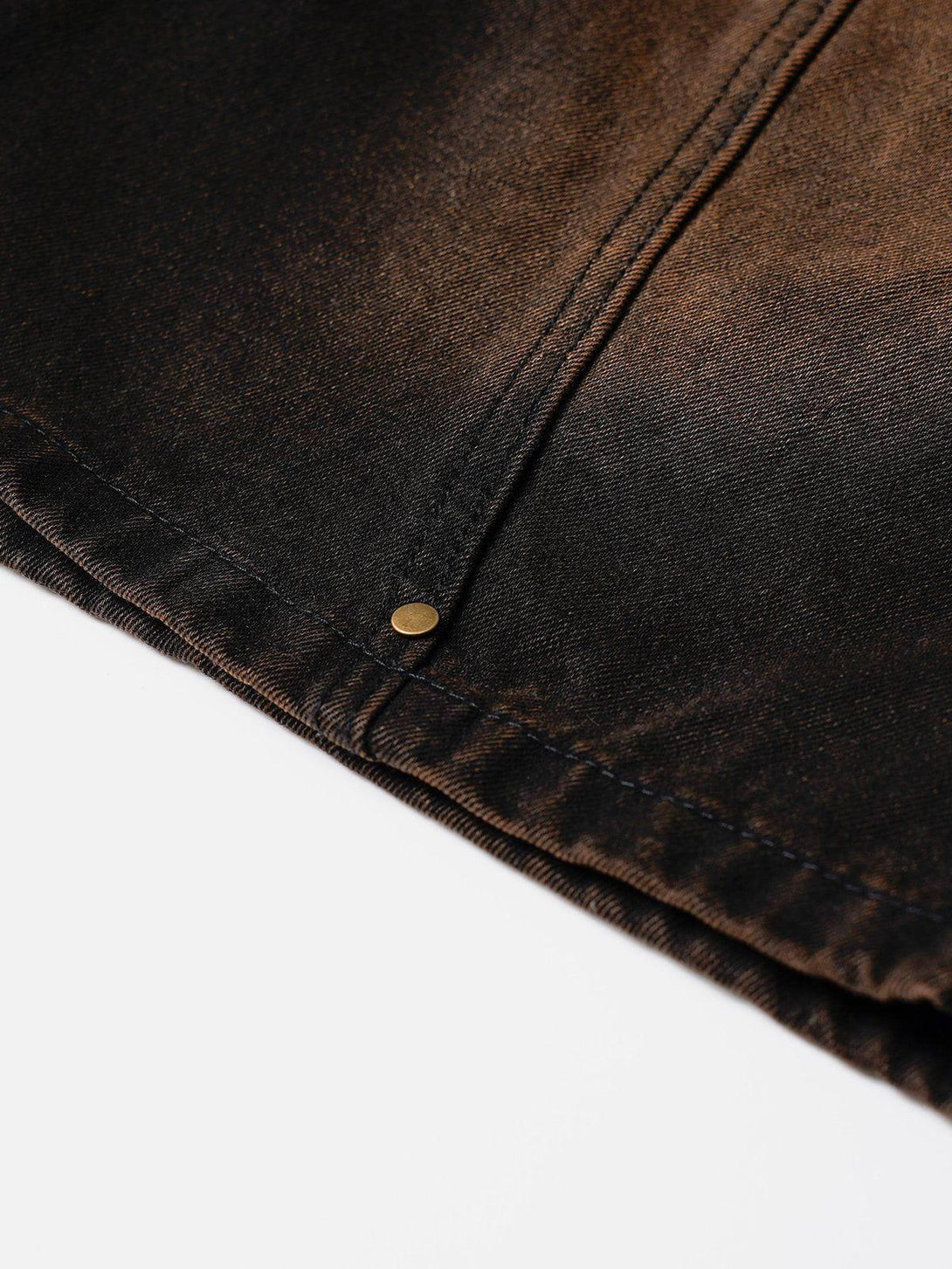 A detailed look at the deconstructive washed jorts by TALISHKO, highlighting the stitching.