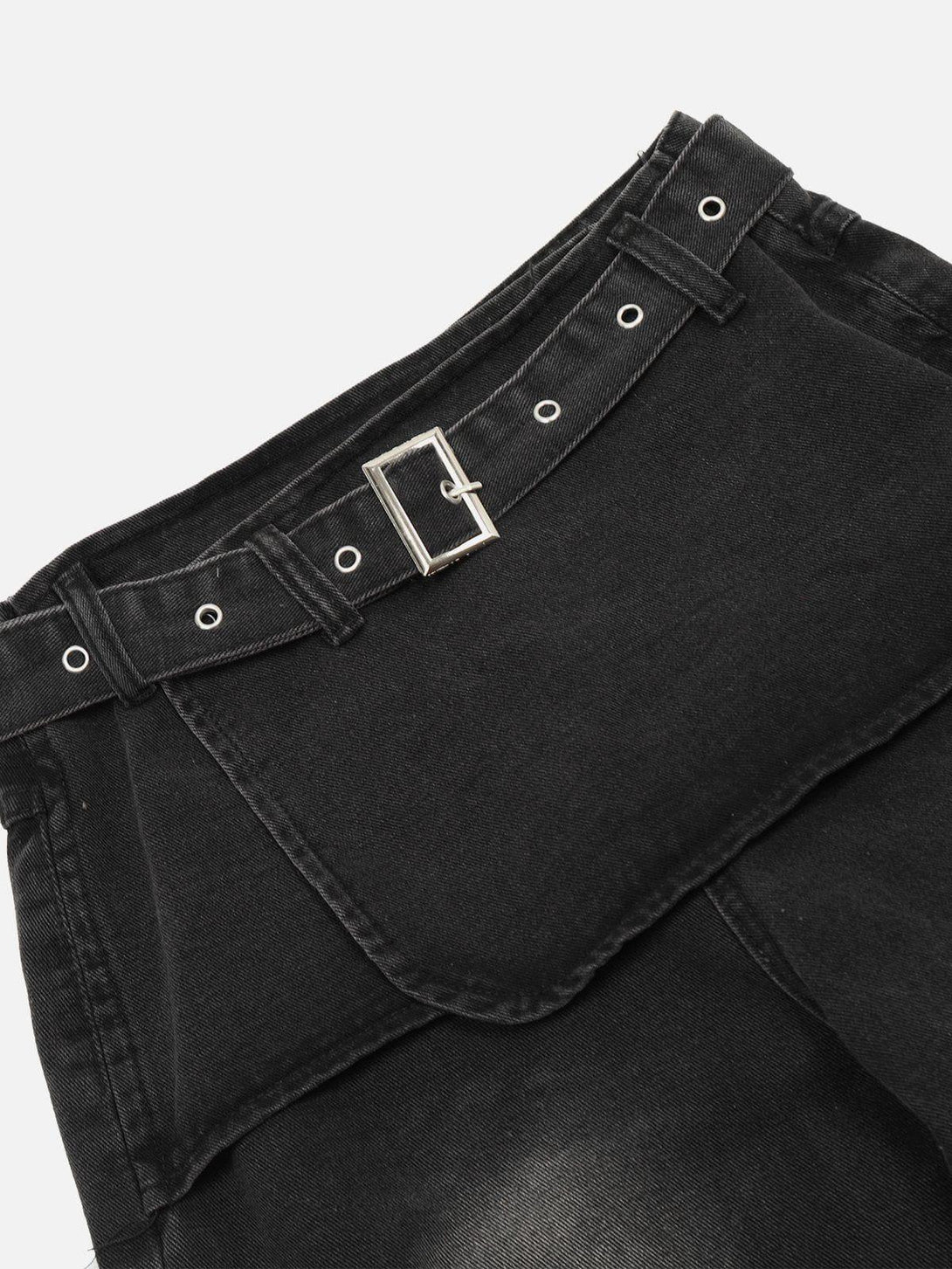 Detailed view of black deconstructive jeans with belt detail by TALISHKO, showcasing texture.