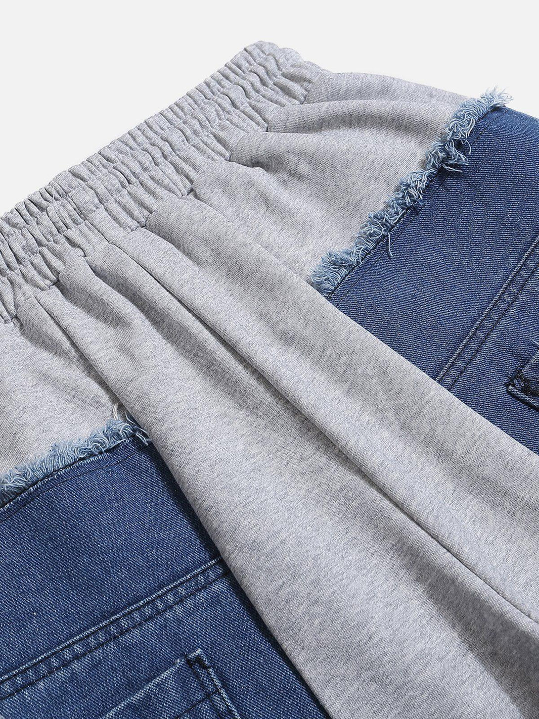 Elastic waistband detail of denim patchwork sweatpants by TALISHKO, highlighting unique design.
