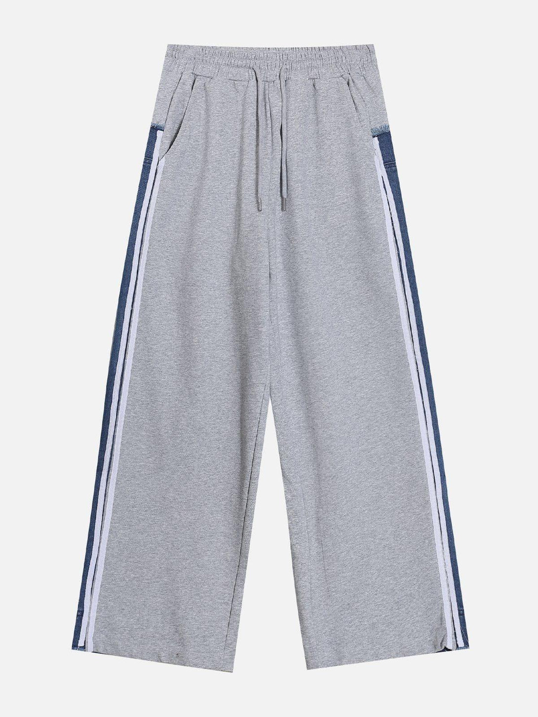 A front view of gray sweatpants with denim patchwork, designed by TALISHKO.
