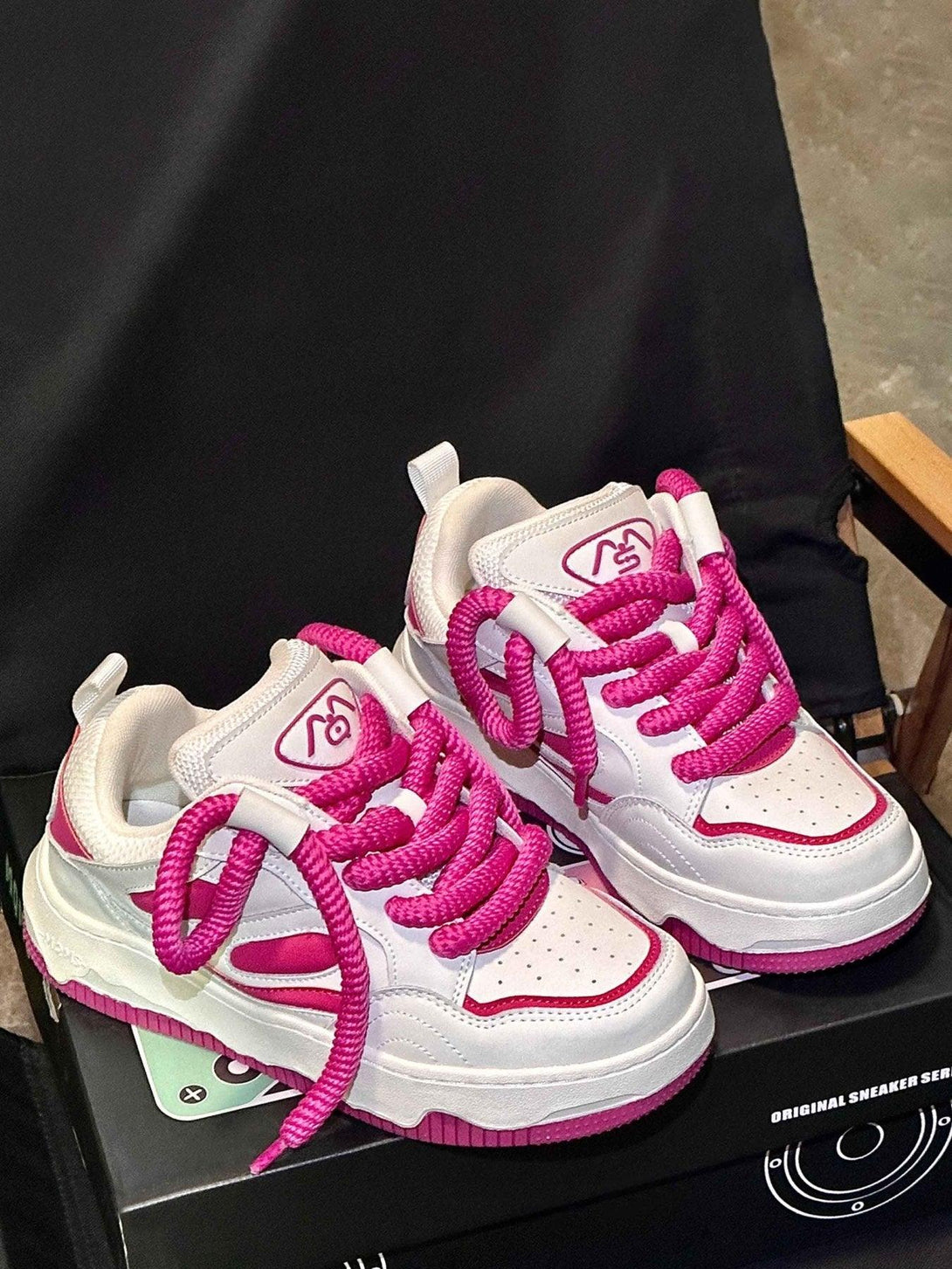 TALISHKO sneakers featuring bold pink laces and thick soles for a stylish statement.