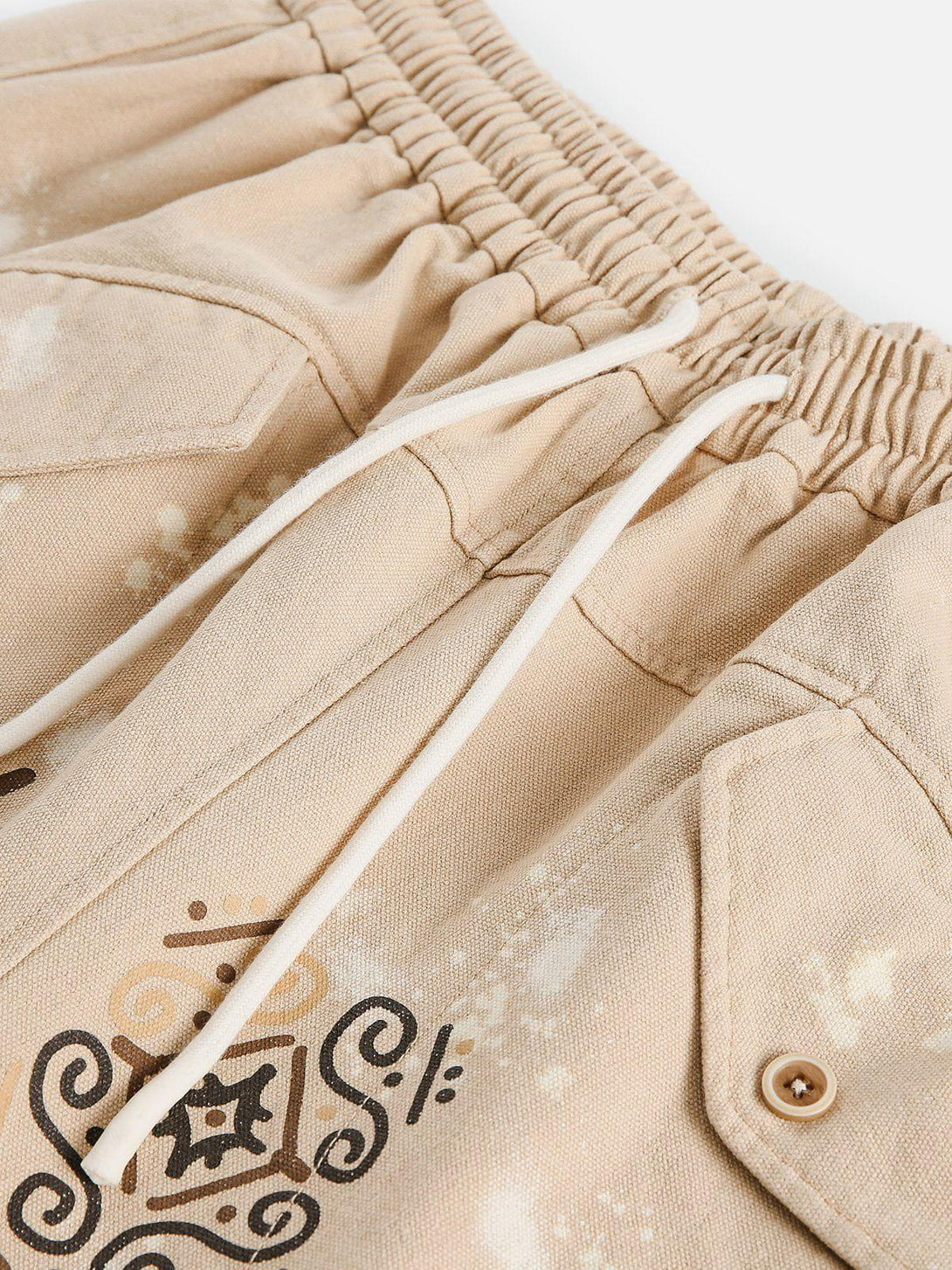 A detailed view of TALISHKO's desert graffiti print shorts, highlighting artistic patterns and texture.