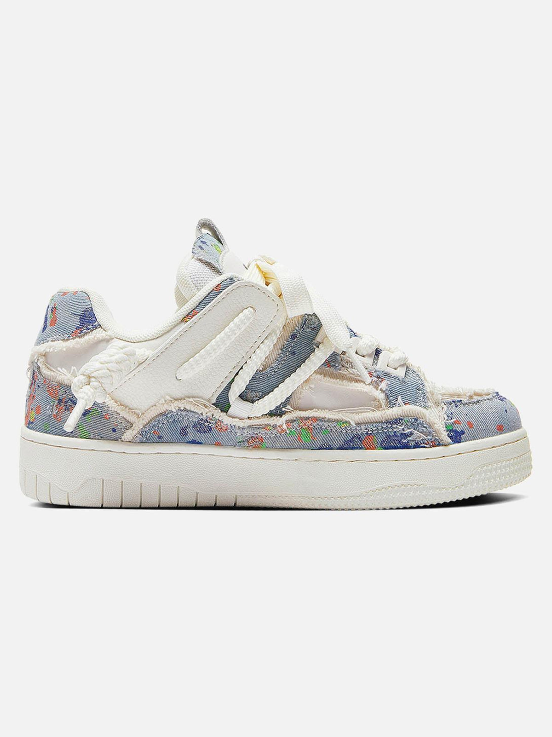 Side view of TALISHKO tassel sneakers featuring colorful, artistic patterns and texture.