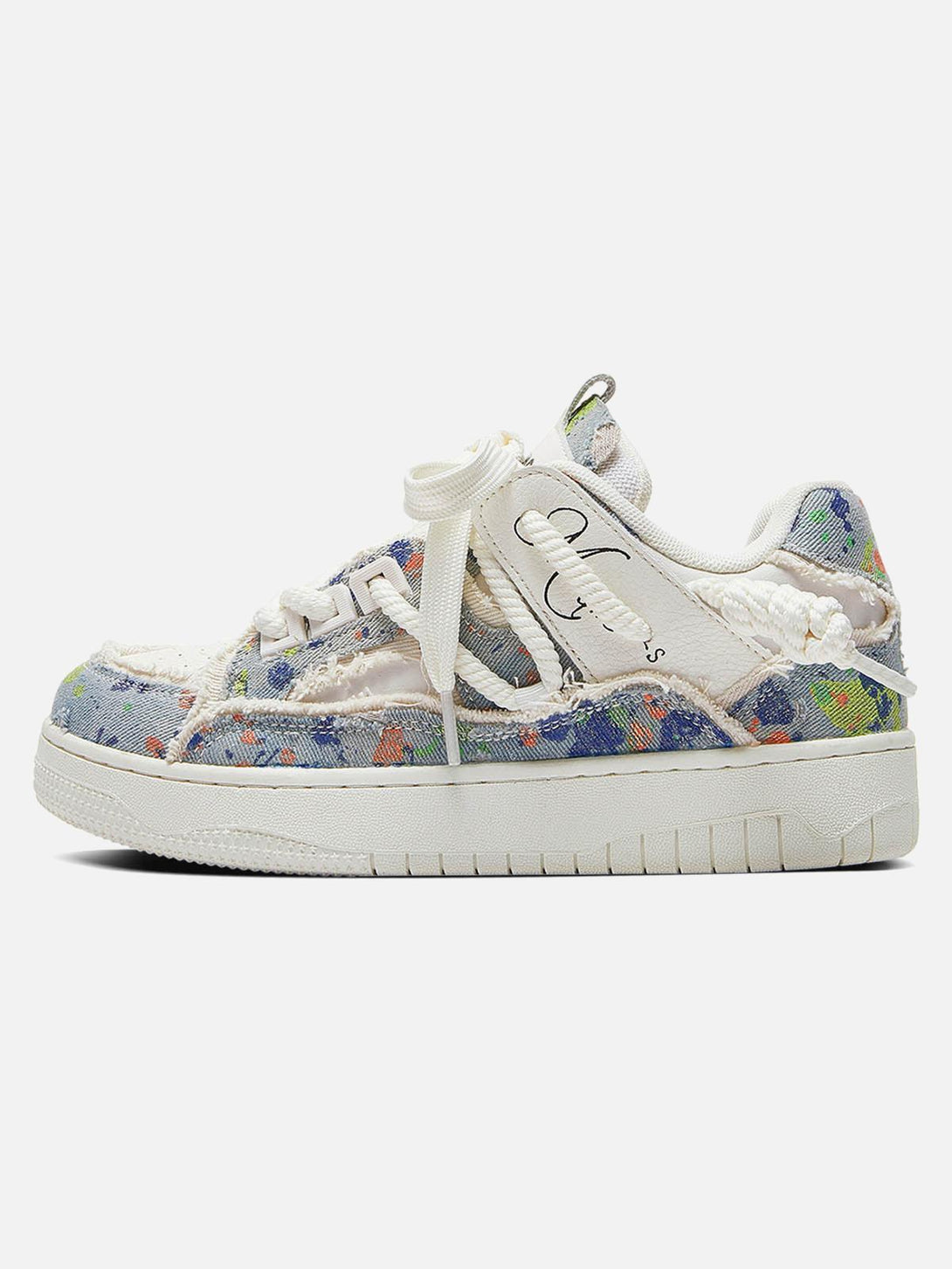 Side profile of TALISHKO sneakers with colorful patterns and tassel details for a unique look.