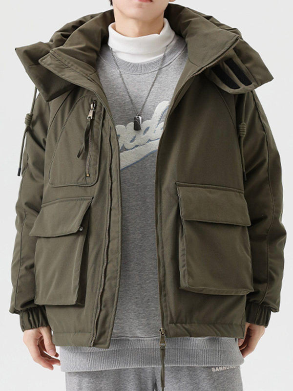 Model wearing a stylish winter coat with detachable hat by TALISHKO, featuring patchwork details.