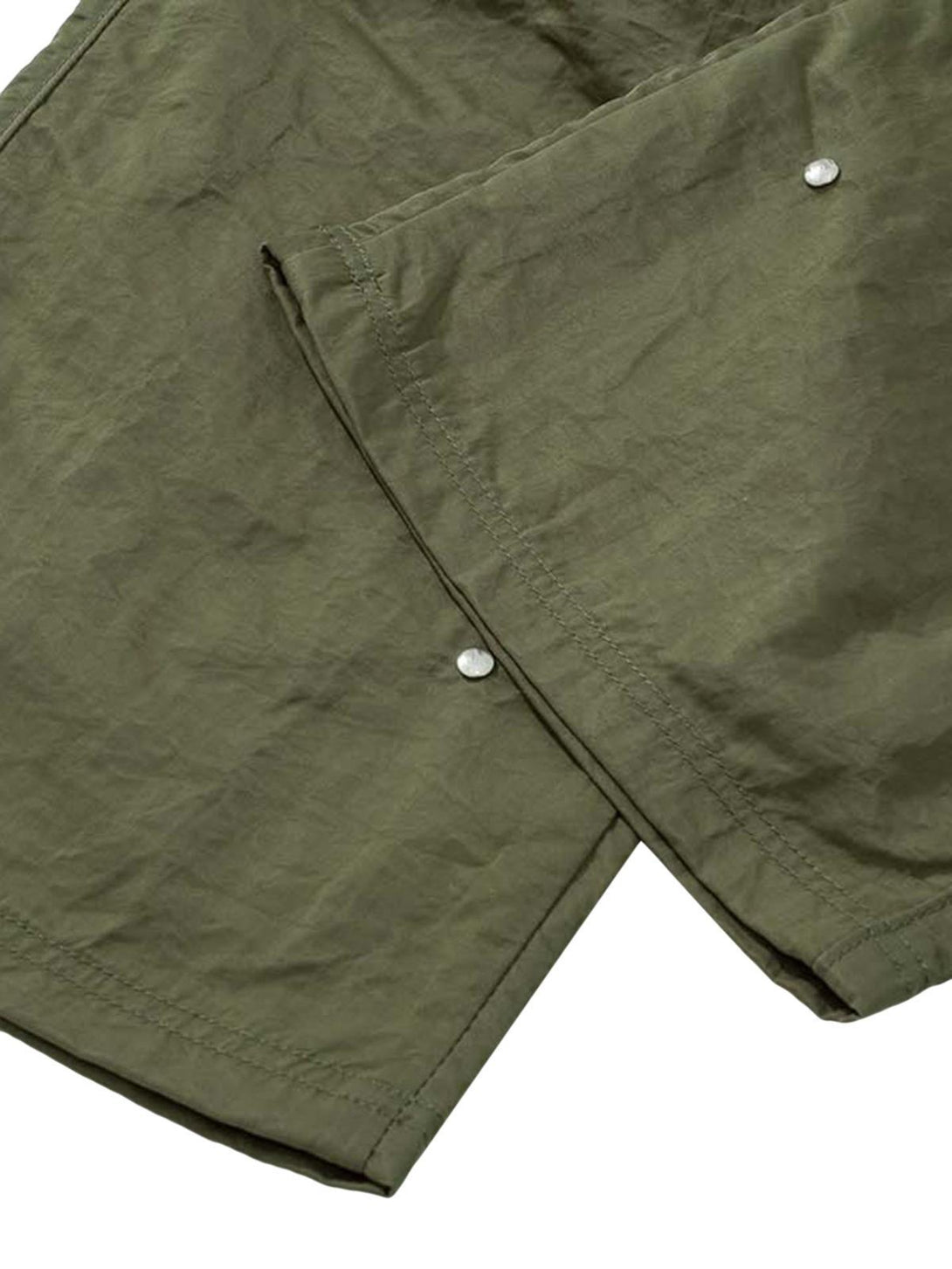 Intricate look at the olive fabric and stitching of TALISHKO detachable work pants.