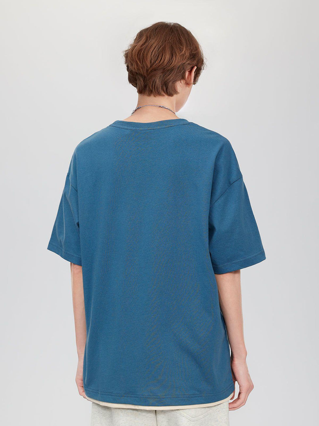Back view of a blue TALISHKO graphic tee, showcasing relaxed fit and casual design.