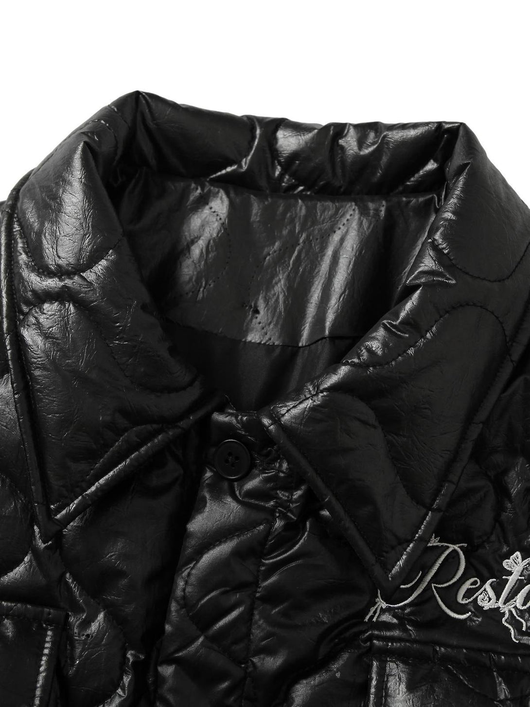 A close look at the TALISHKO diamond-quilted jacket, highlighting its glossy texture and embroidery.