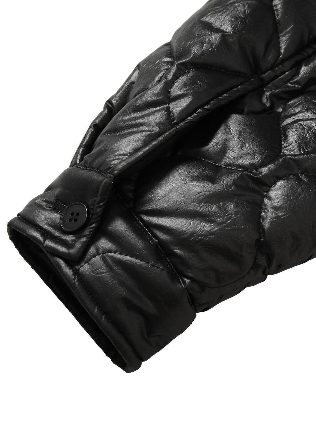 Detailed view of TALISHKO's diamond-quilted jacket sleeve, showcasing button and texture.