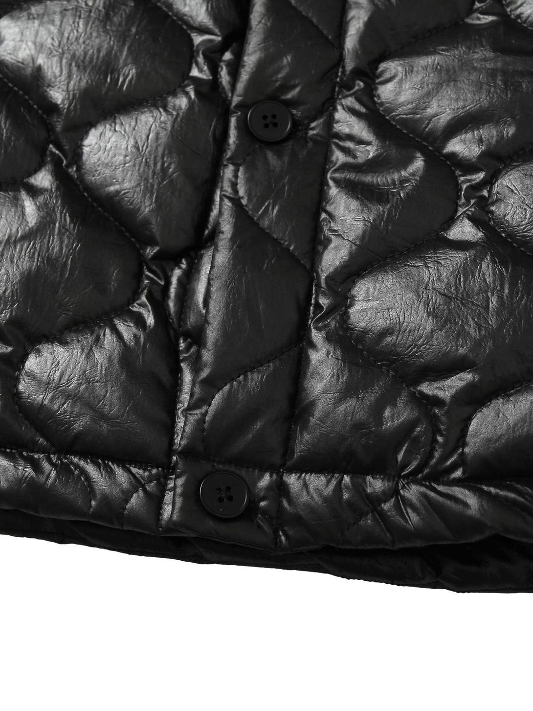 Detailed look at TALISHKO's diamond-quilted jacket, focusing on glossy fabric and buttons.