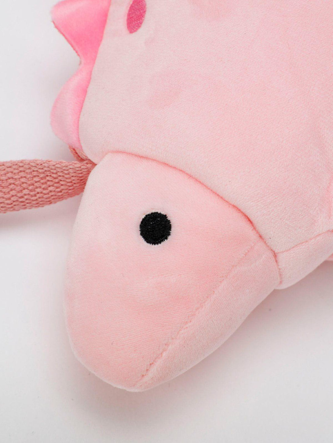 A detailed view of the playful pink dinosaur crossbody bag by TALISHKO, highlighting its cute design.