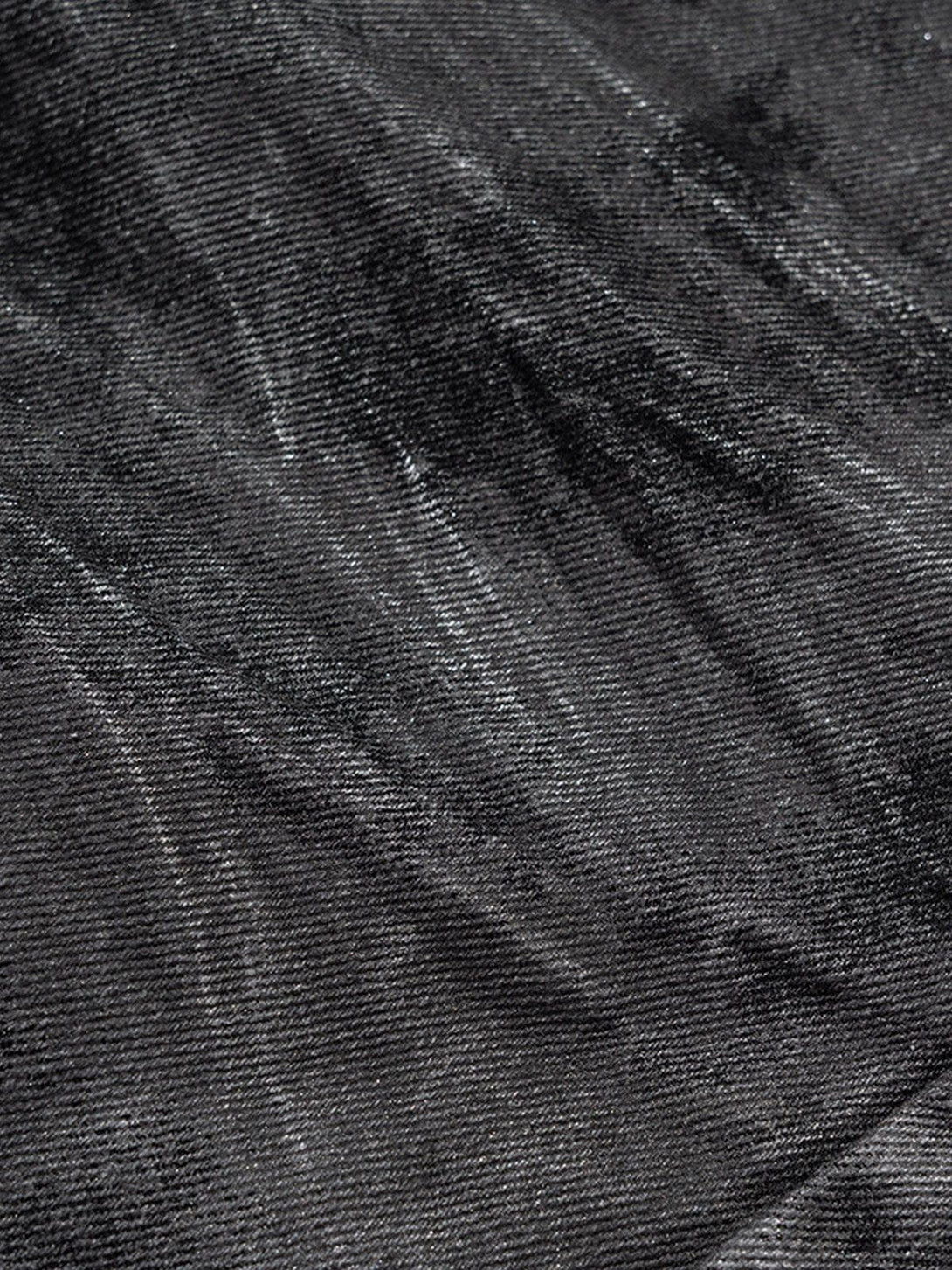 Zoomed-in texture of TALISHKO dip-dye washed jeans showcasing the rich dark fabric.