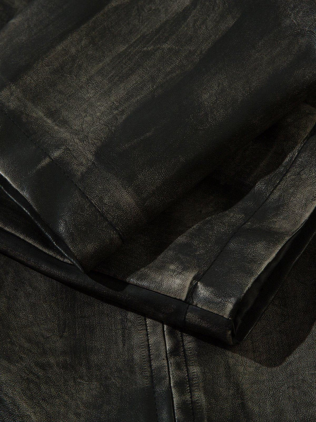 Intricate look at TALISHKO's dirt-colored faux leather jacket, highlighting its unique texture.