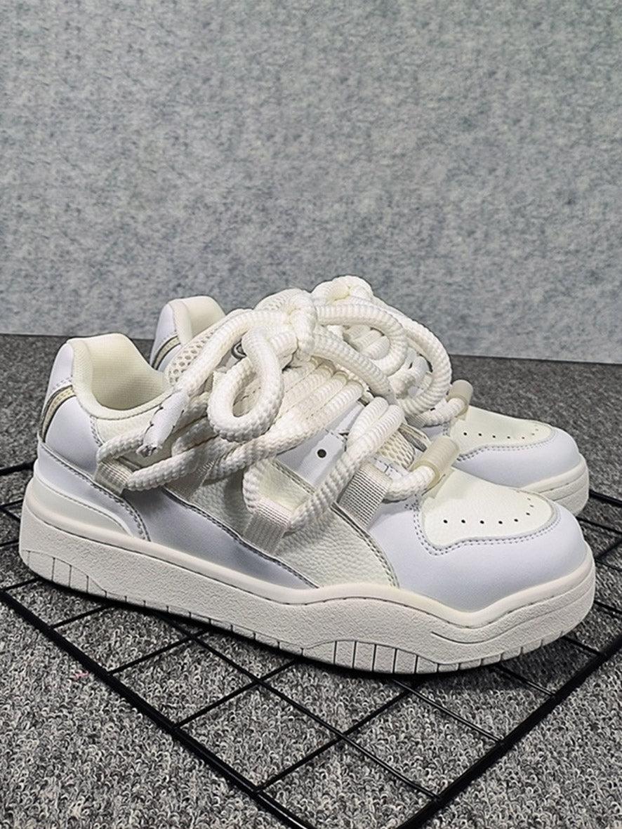 White skateboard shoes by TALISHKO, highlighting a unique braided lace design.