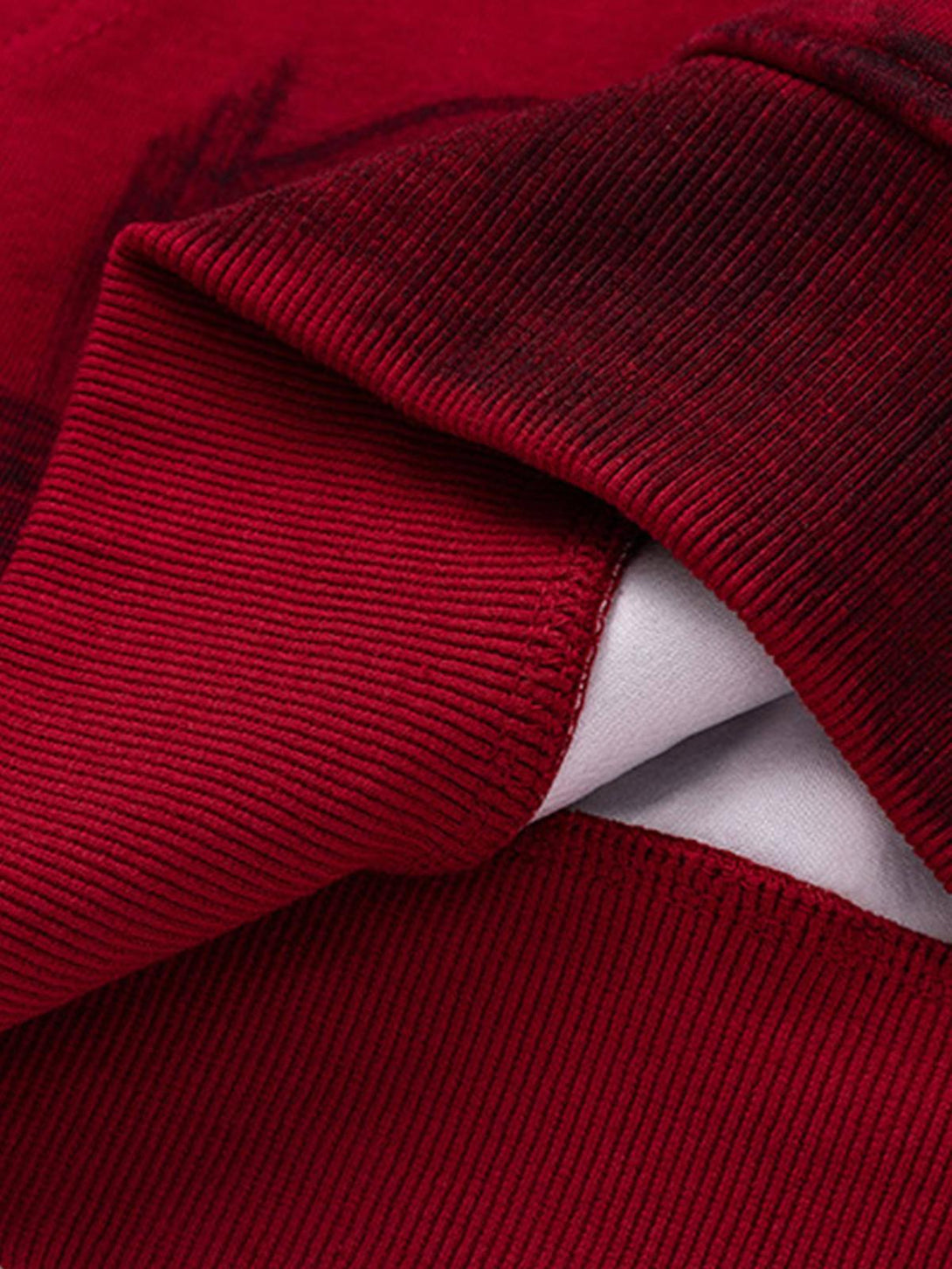A detailed view of TALISHKO hoodie fabric, highlighting rich red texture and stitching.
