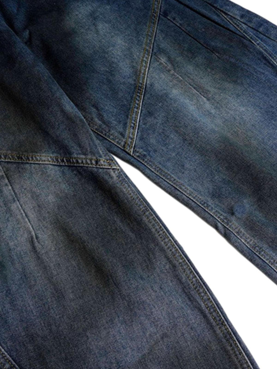 A detailed view of TALISHKO's Dirty Dye Baggy Barrel Jeans, highlighting unique stitching.