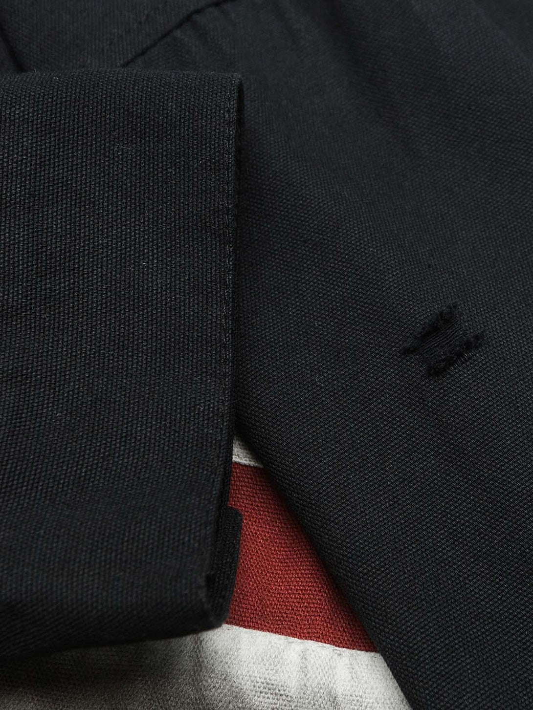 Detailed fabric and stitching on TALISHKO's polo, showcasing the rich texture and quality.