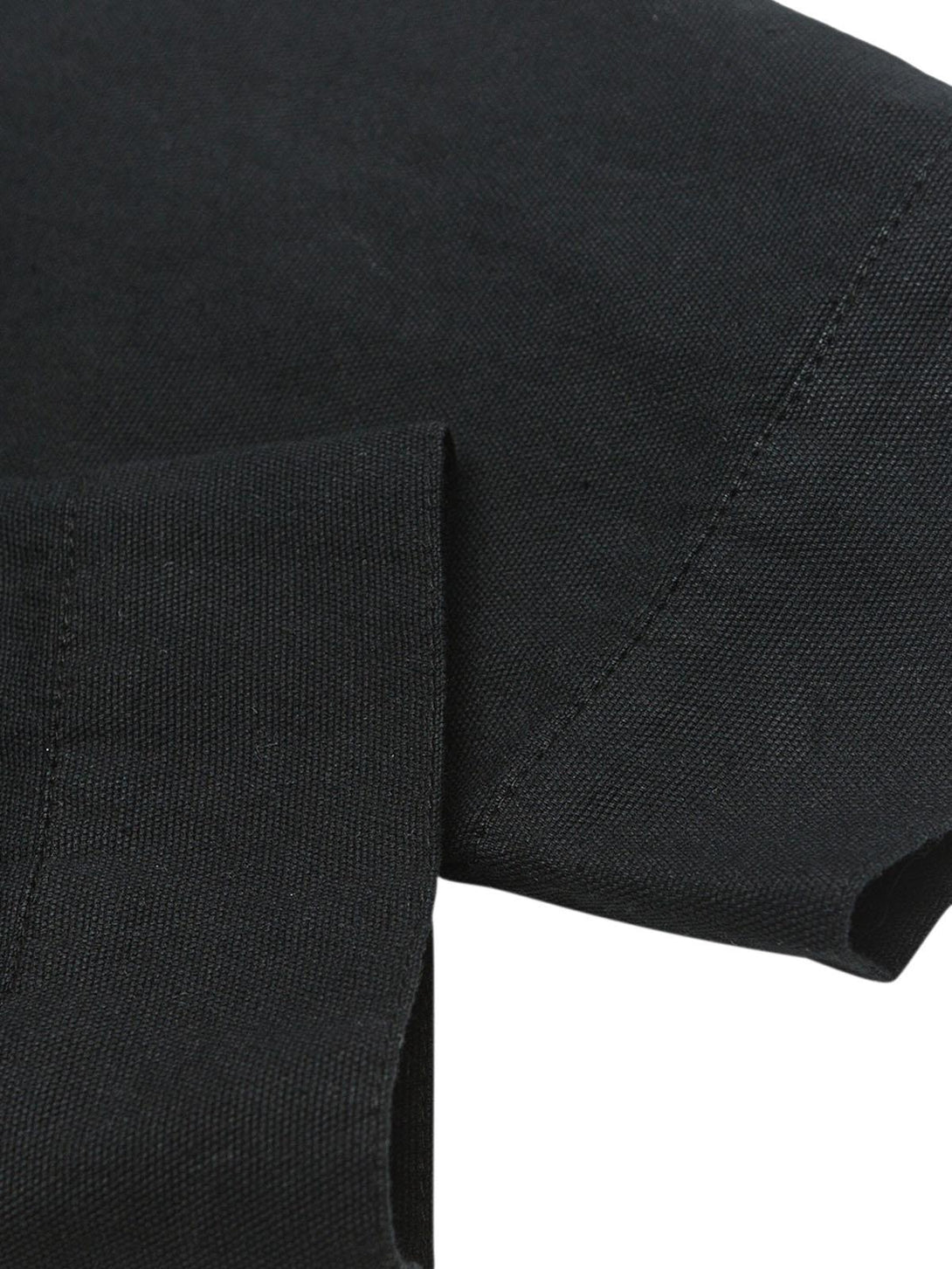 Zoomed-in texture of TALISHKO's black polo sleeve, highlighting the fabric and quality.