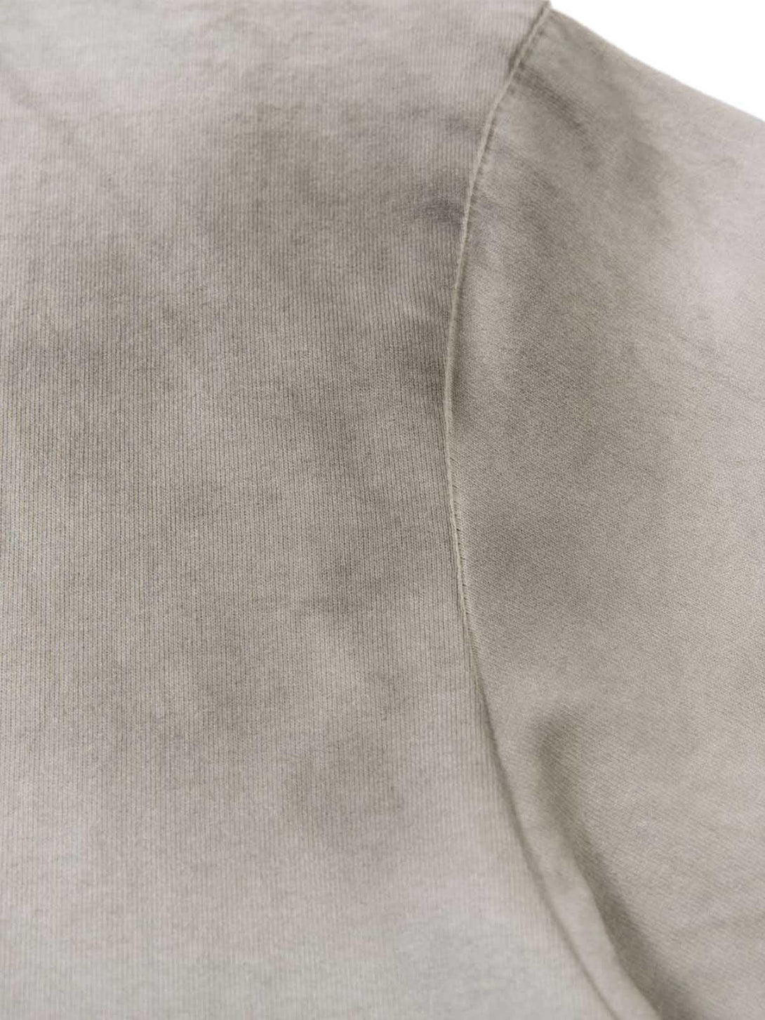 A close-up of the soft, dirty-dyed fabric on a TALISHKO crew neck T-shirt, highlighting texture.
