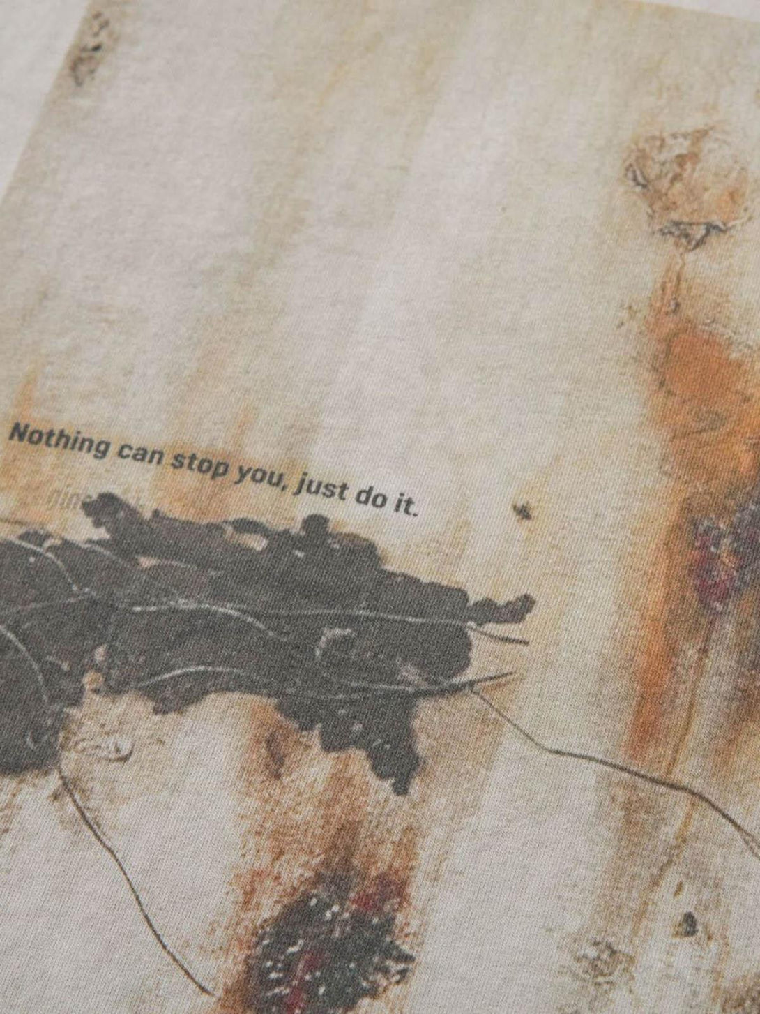 A close-up of a TALISHKO T-shirt featuring an artistic print and motivational text.