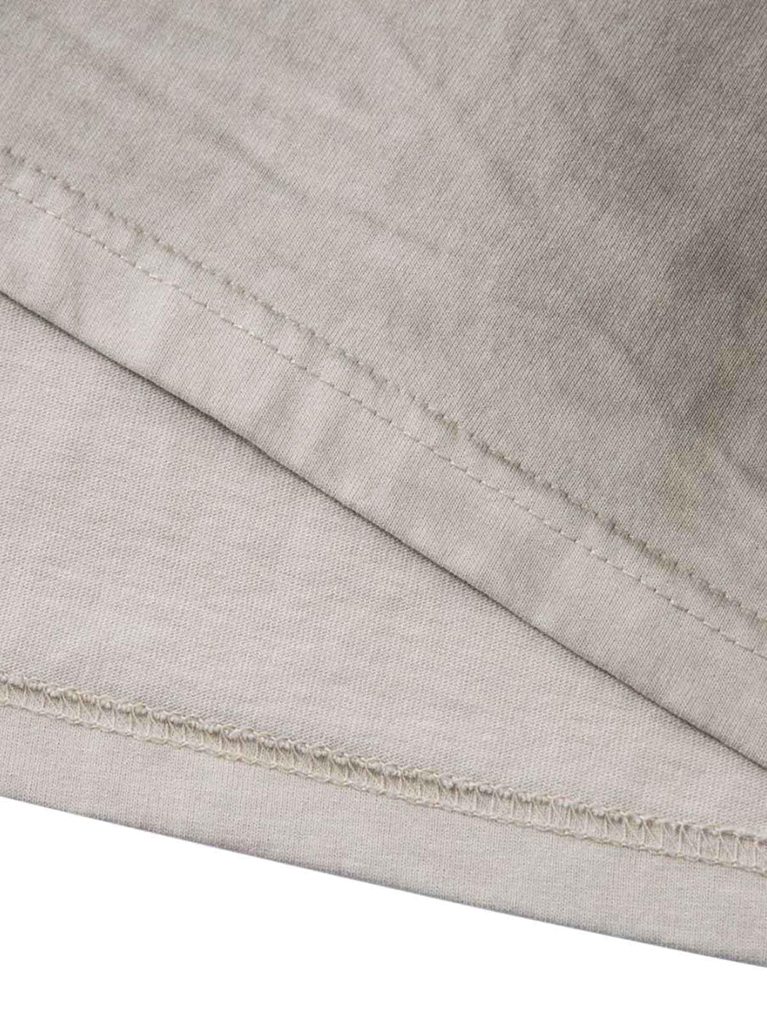 Detailed fabric and stitching of the TALISHKO dirty-dyed washed crew neck T-shirt.