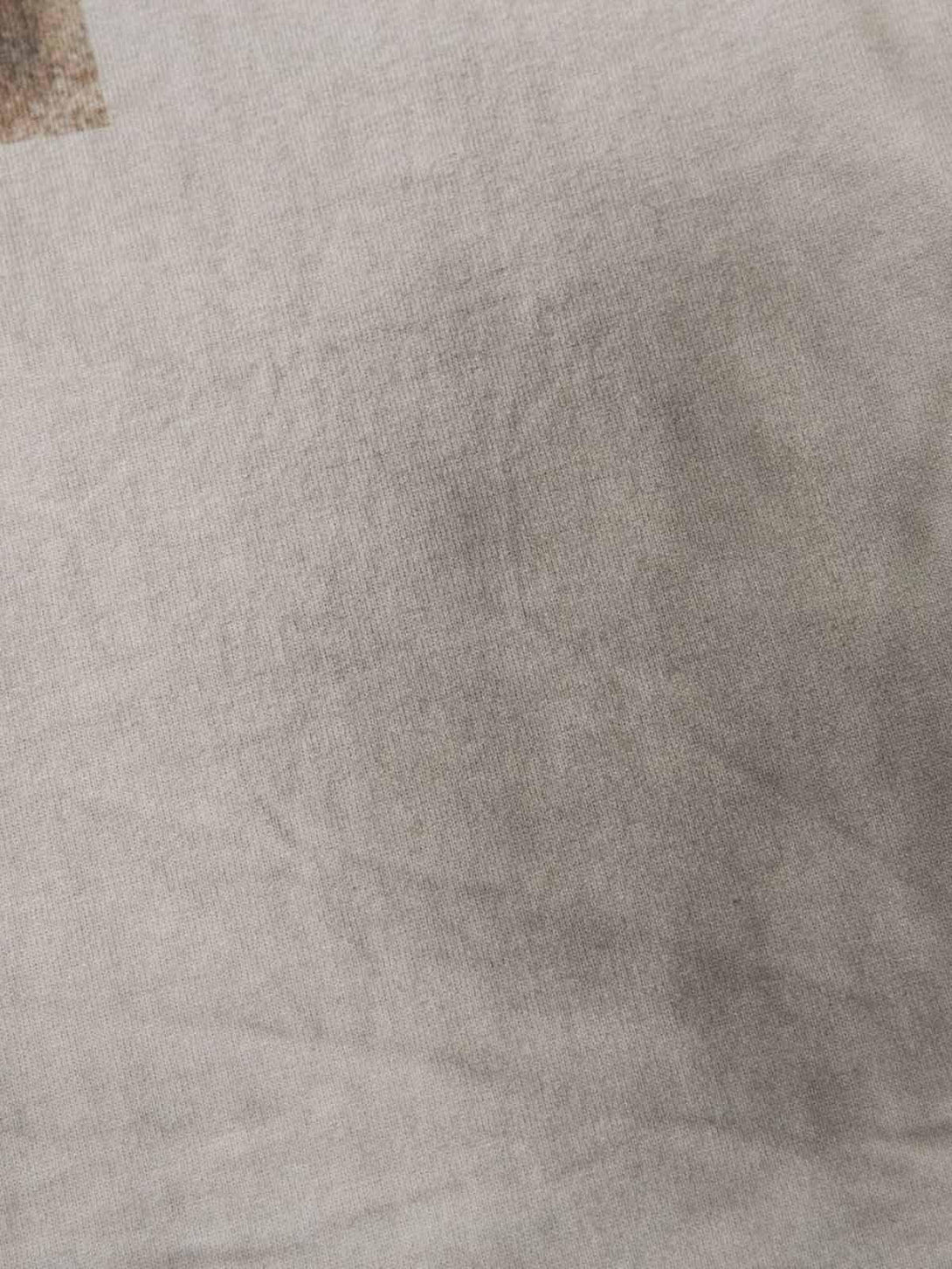 Zoomed-in texture of TALISHKO's dirty-dyed washed crew neck T-shirt, showcasing fabric detail.