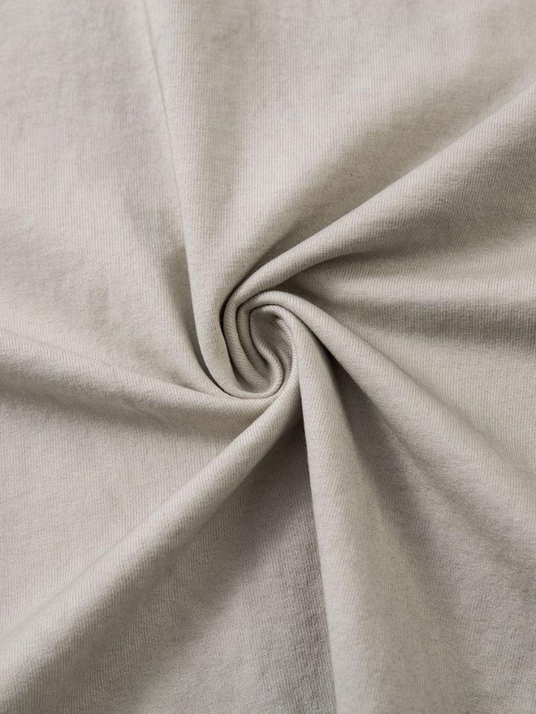 A tight crop highlighting TALISHKO's soft, dirty-dyed fabric texture on a crew neck T-shirt.