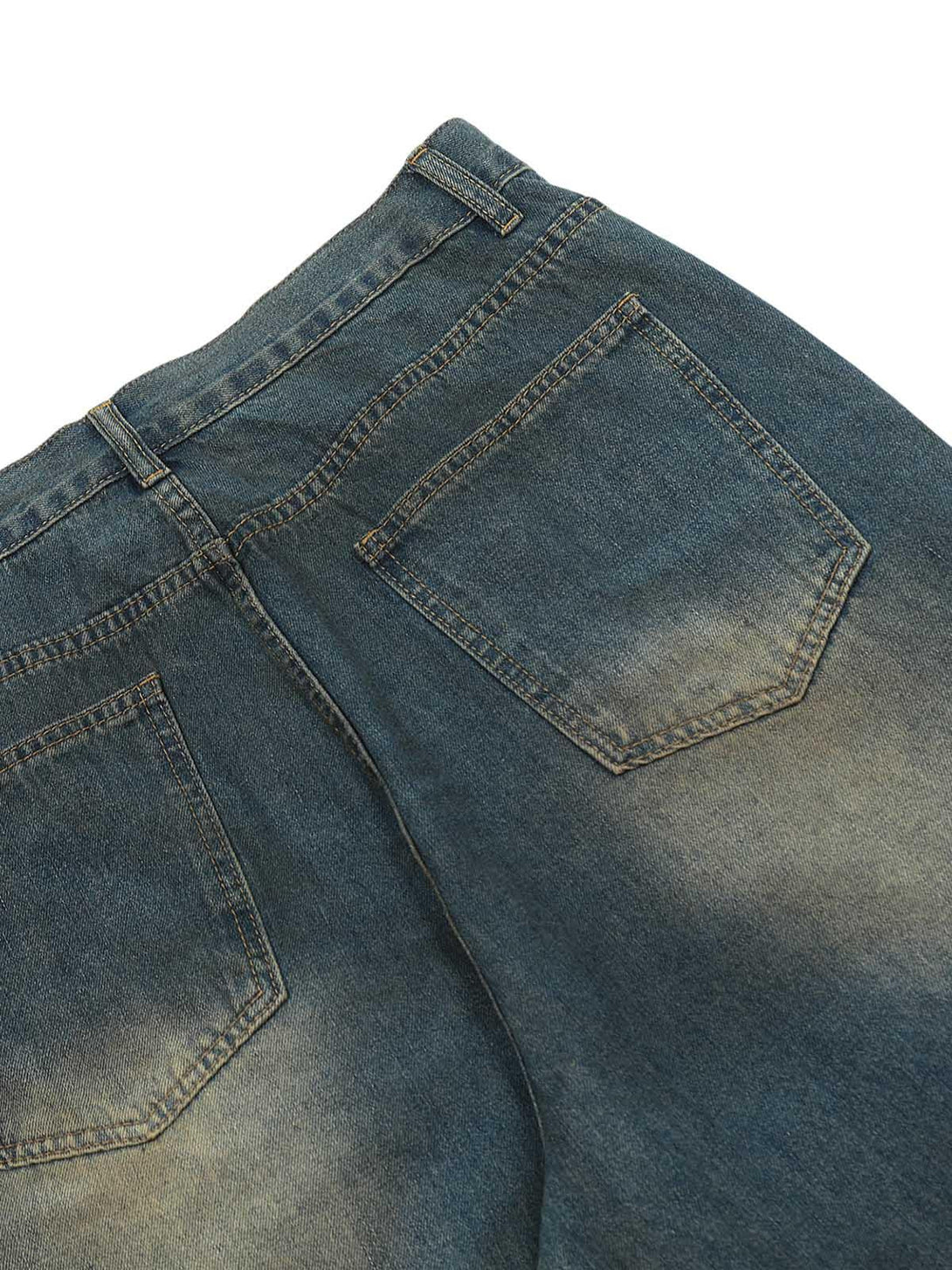 Intricate view of TALISHKO jeans' back pockets, highlighting the unique washed denim texture.