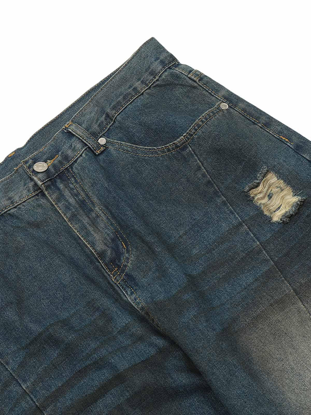 A close-up of TALISHKO jeans, highlighting distressed detail and washed denim texture.